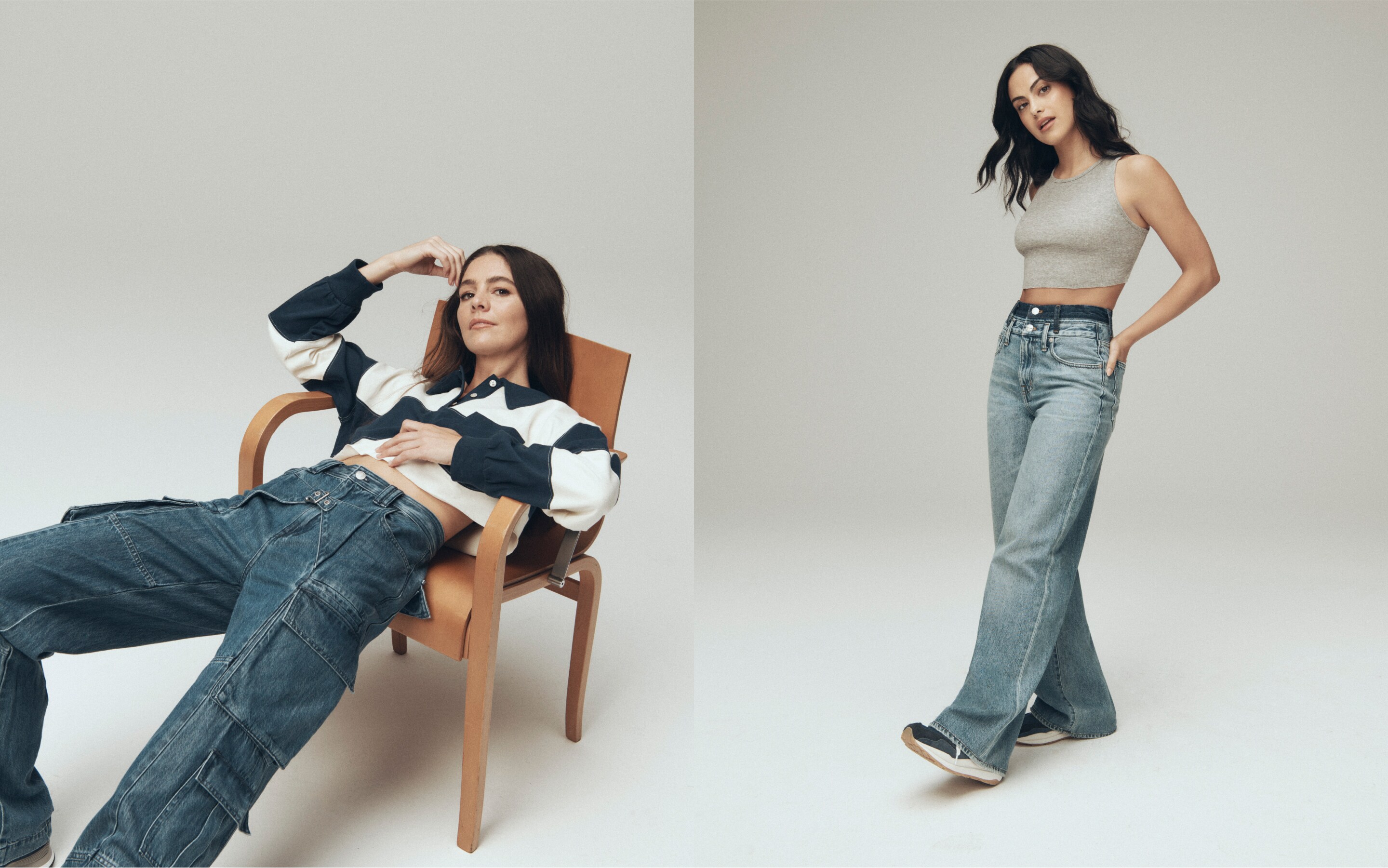 man with long brown hair and hat lounging on a large cream couch in light wash jeans and a grey t-shirt