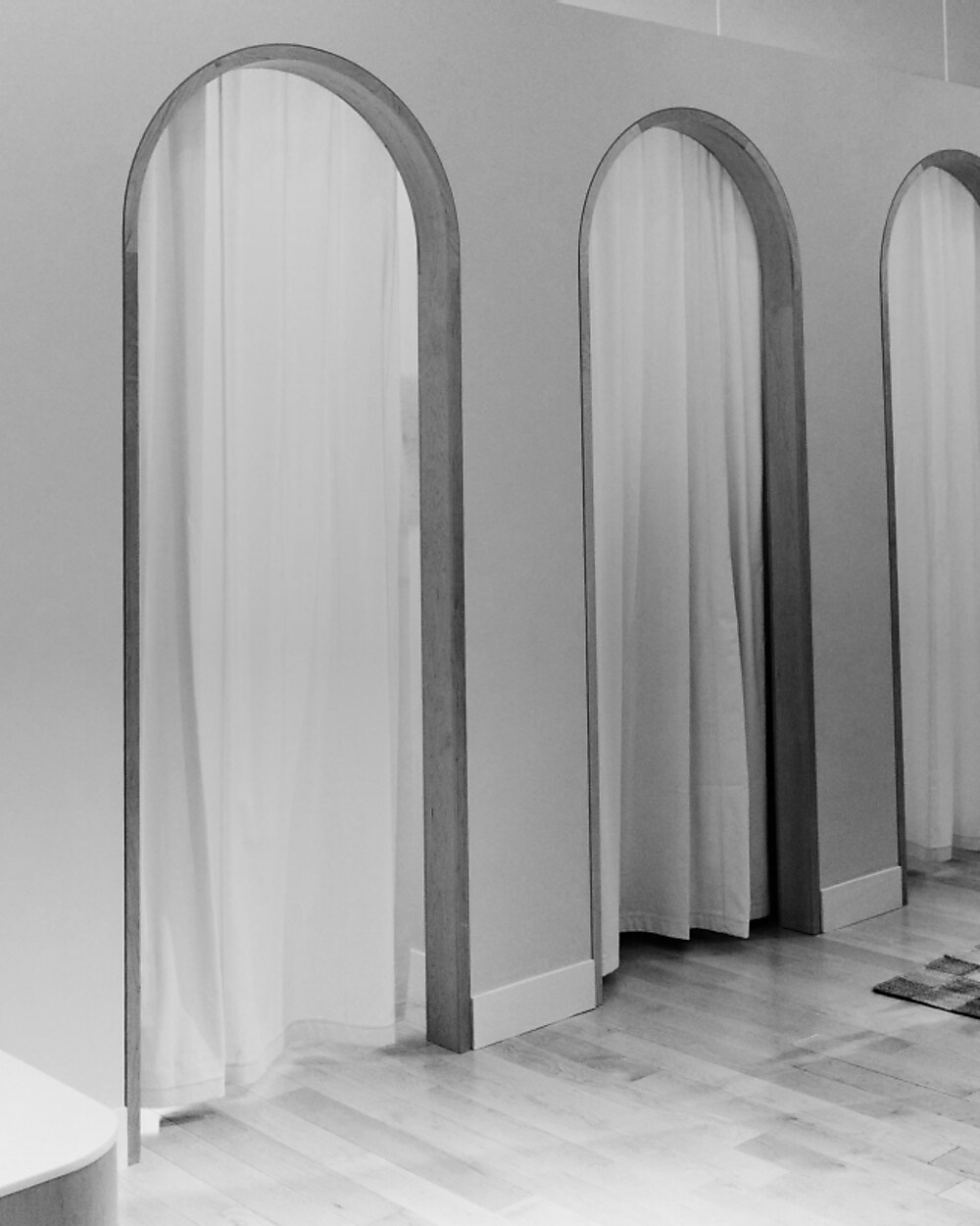 man standing in front of a parachute with classic beige shorts, white top, and a beige shirt