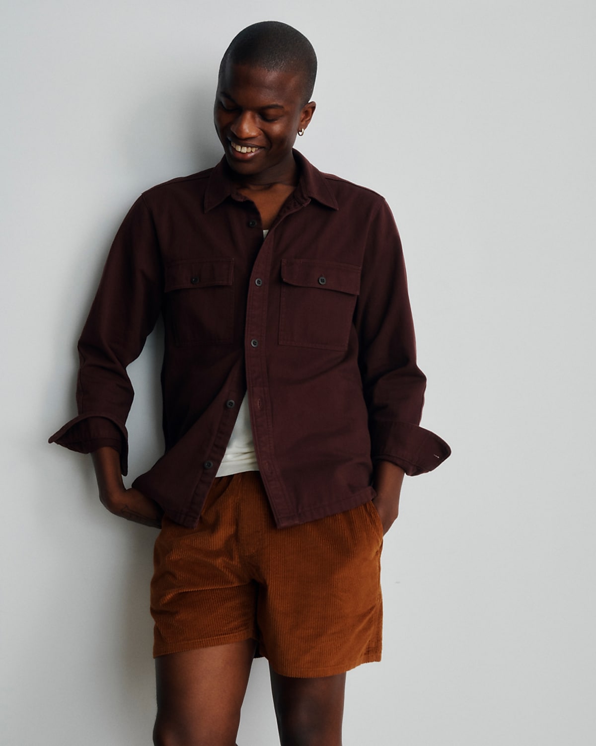 man wearing marron shirt and desert colored shorts
