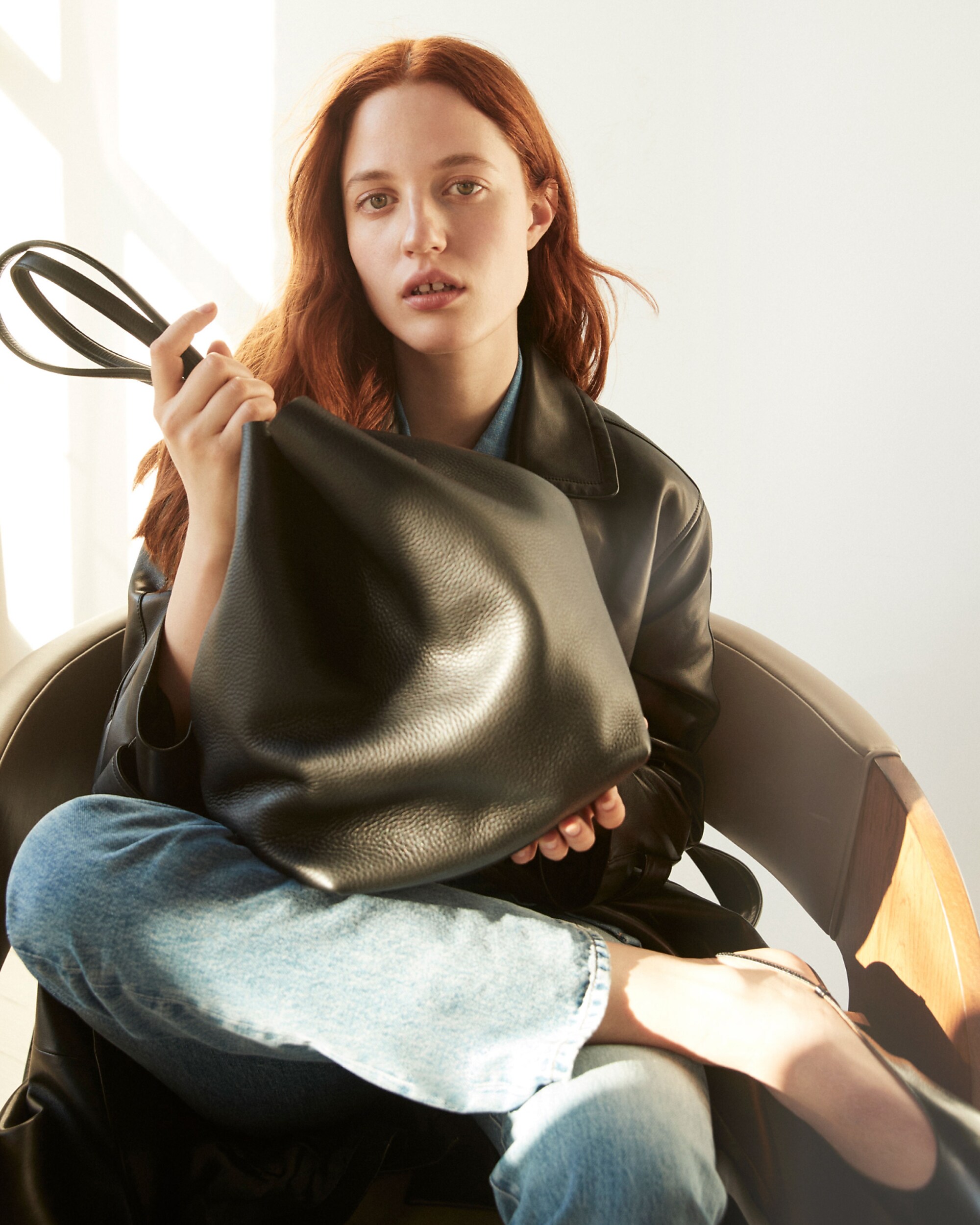 man standing in front of a parachute with classic beige shorts, white top, and a beige shirt