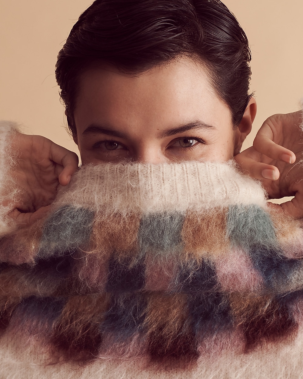 man standing in front of a parachute with classic beige shorts, white top, and a beige shirt