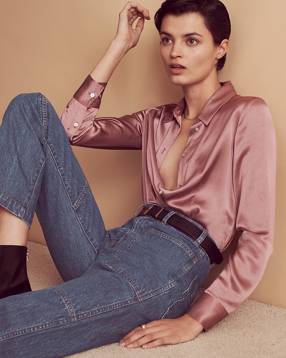 man standing in front of a parachute with classic beige shorts, white top, and a beige shirt