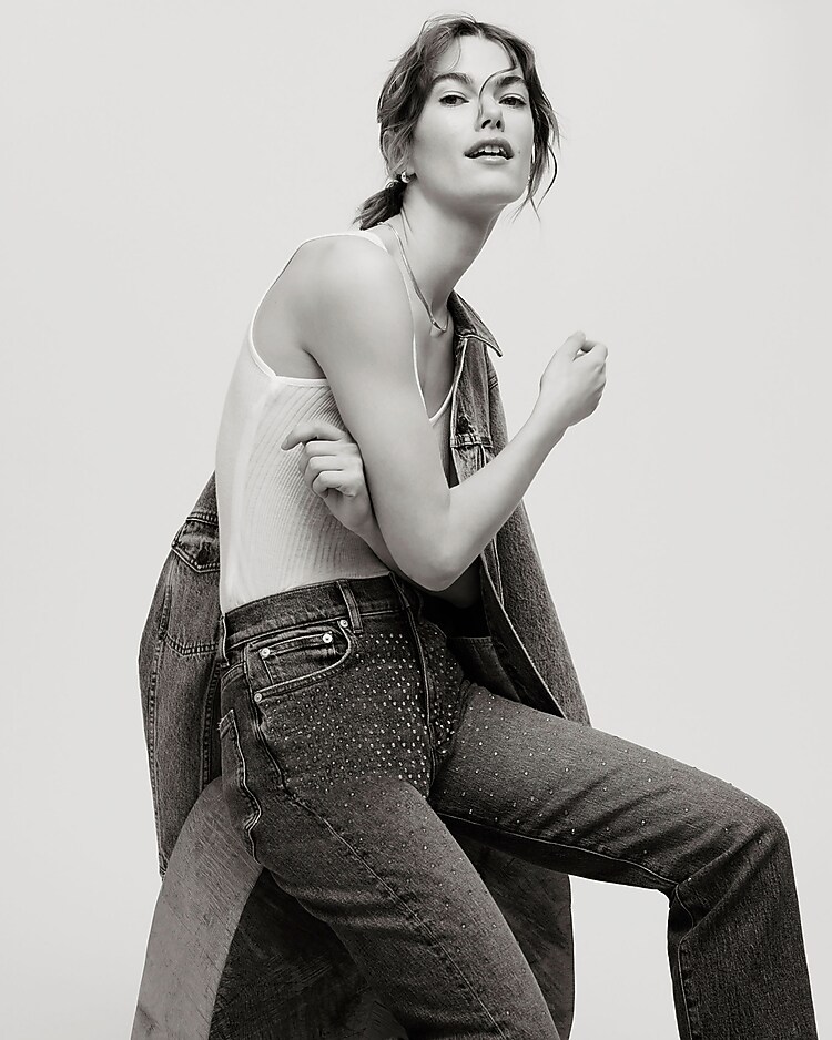 man standing in front of a parachute with classic beige shorts, white top, and a beige shirt