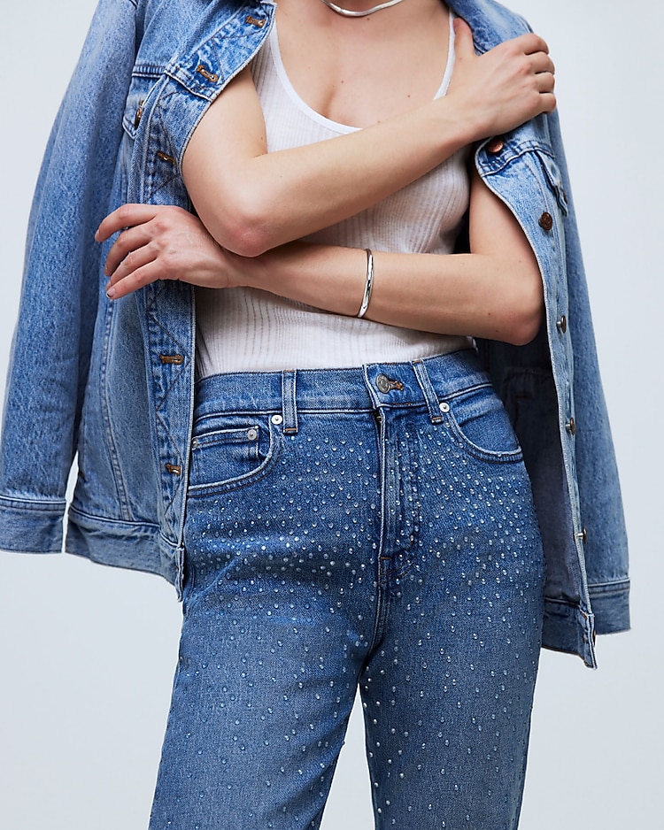 man standing in front of a parachute with classic beige shorts, white top, and a beige shirt