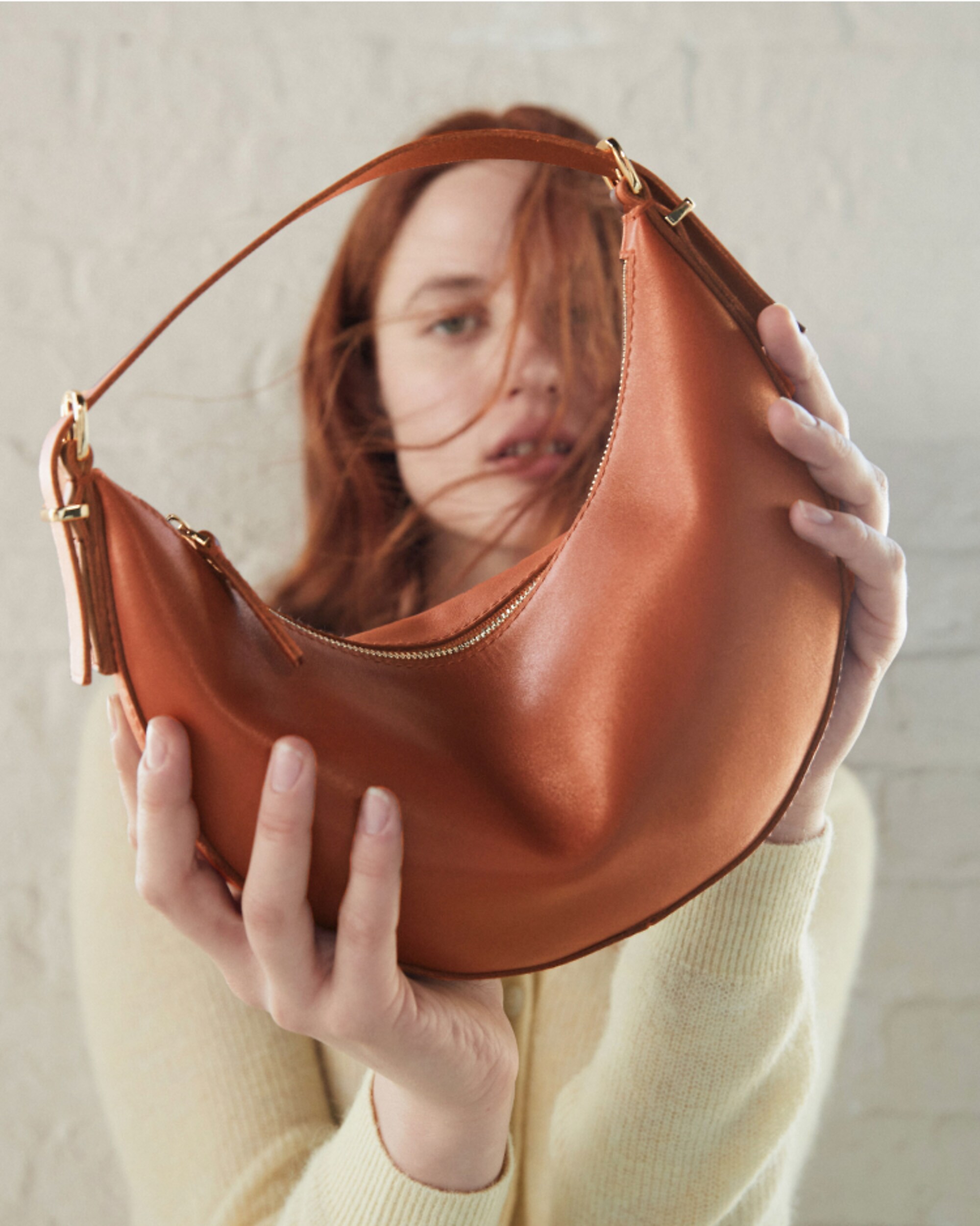 man standing in front of a parachute with classic beige shorts, white top, and a beige shirt