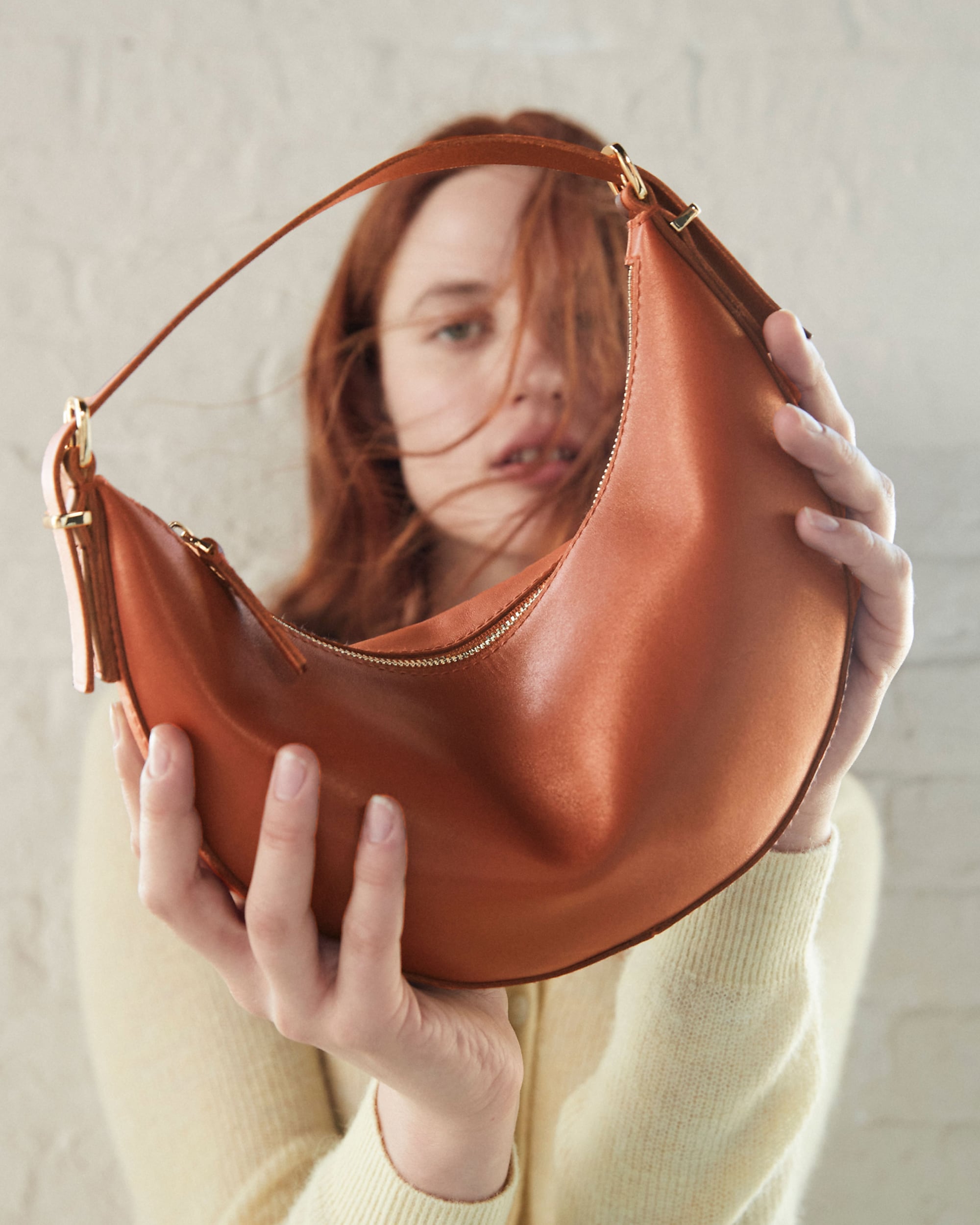man standing in front of a parachute with classic beige shorts, white top, and a beige shirt