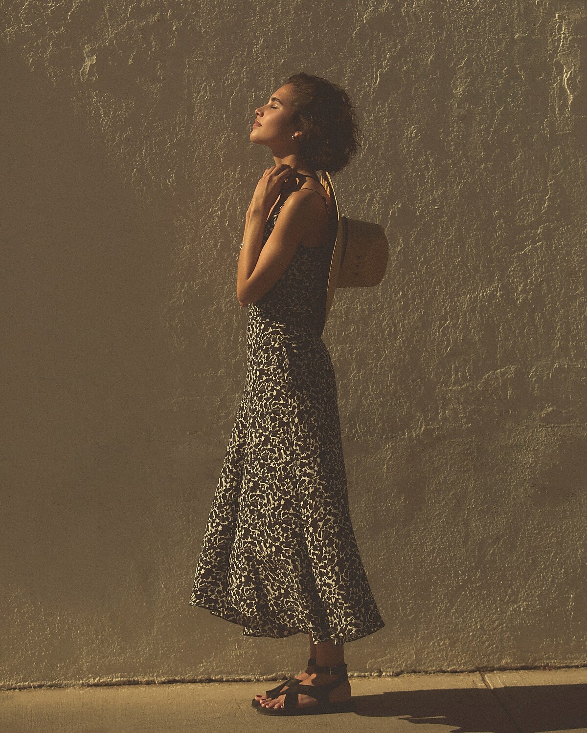 man standing in front of a parachute with classic beige shorts, white top, and a beige shirt