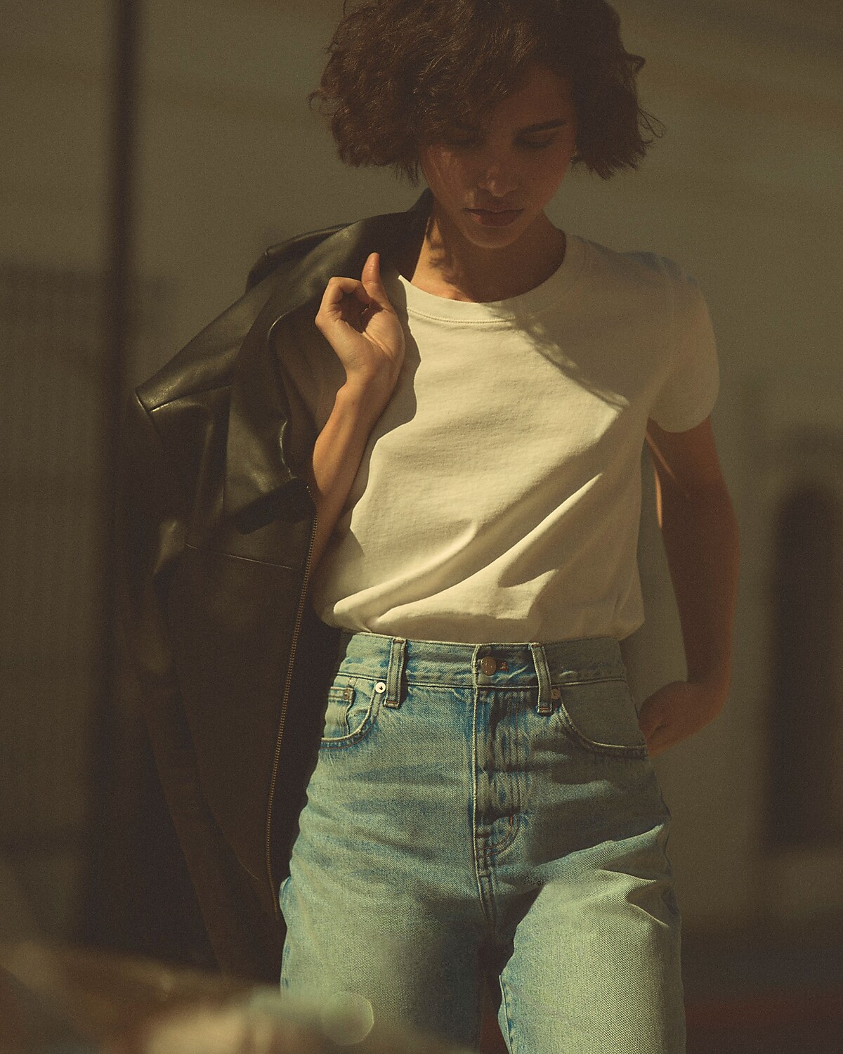 man standing in front of a parachute with classic beige shorts, white top, and a beige shirt