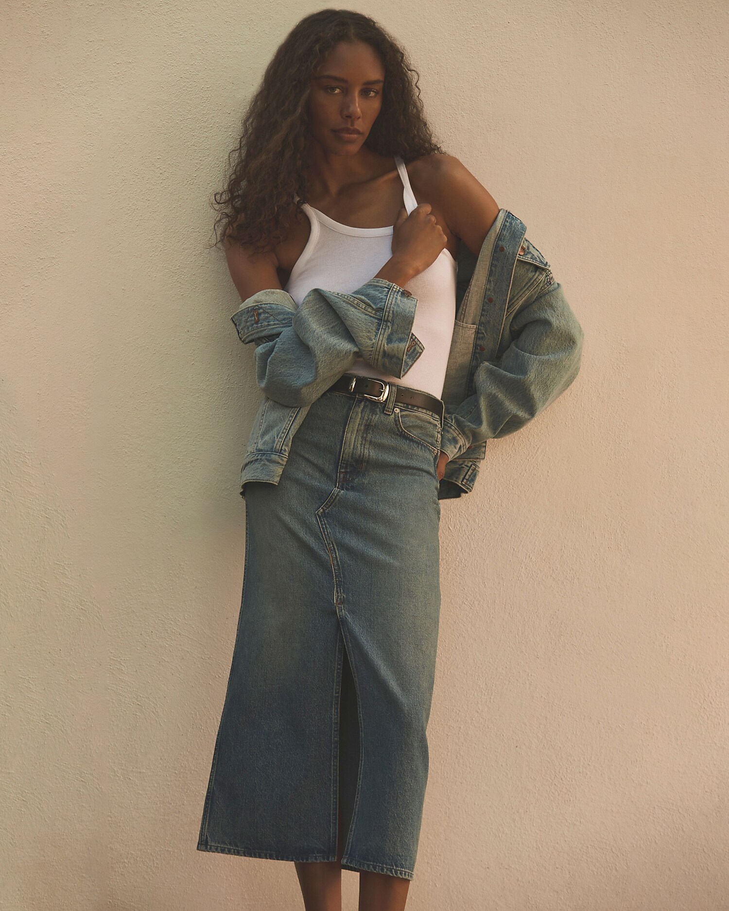 man standing in front of a parachute with classic beige shorts, white top, and a beige shirt