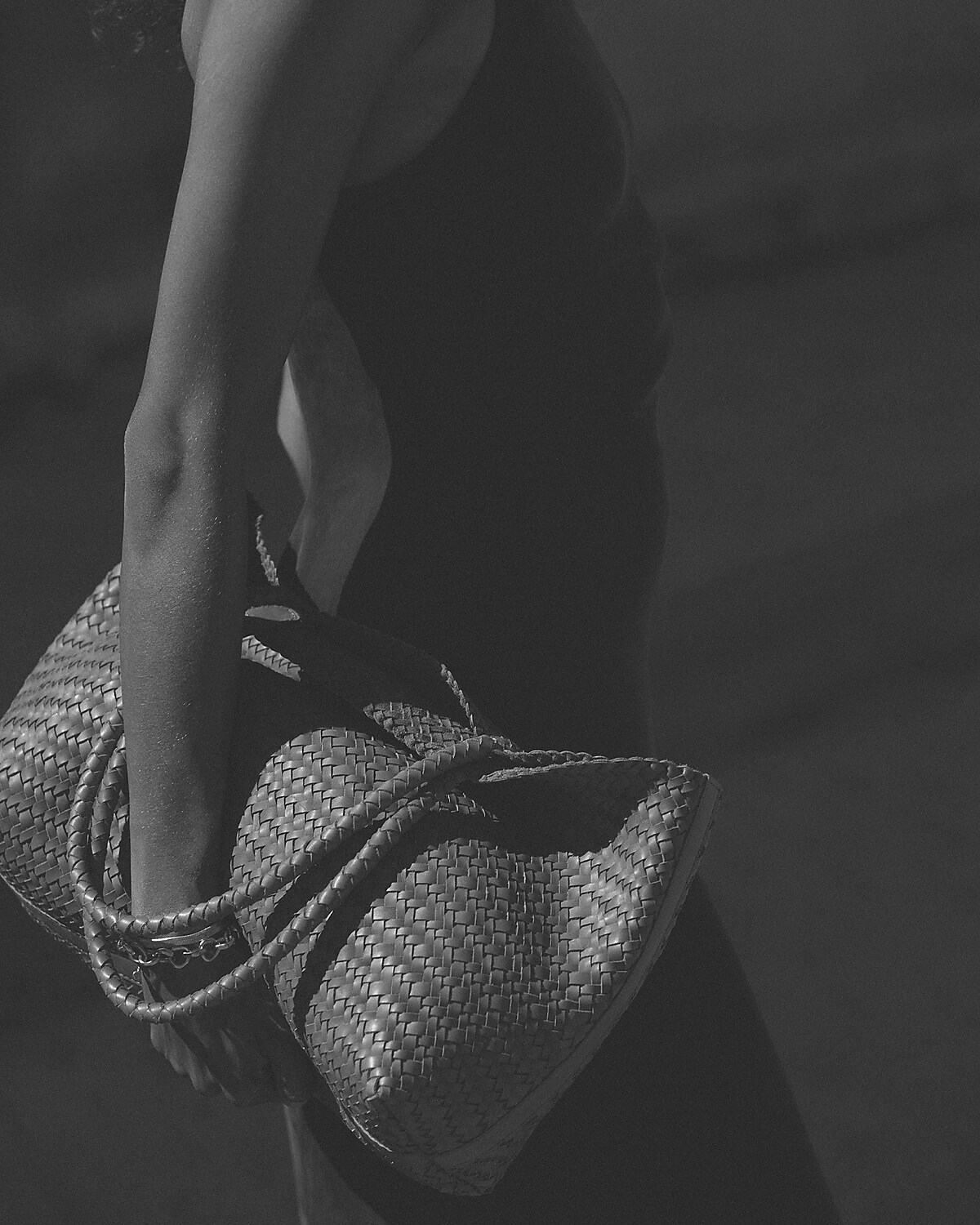 man standing in front of a parachute with classic beige shorts, white top, and a beige shirt