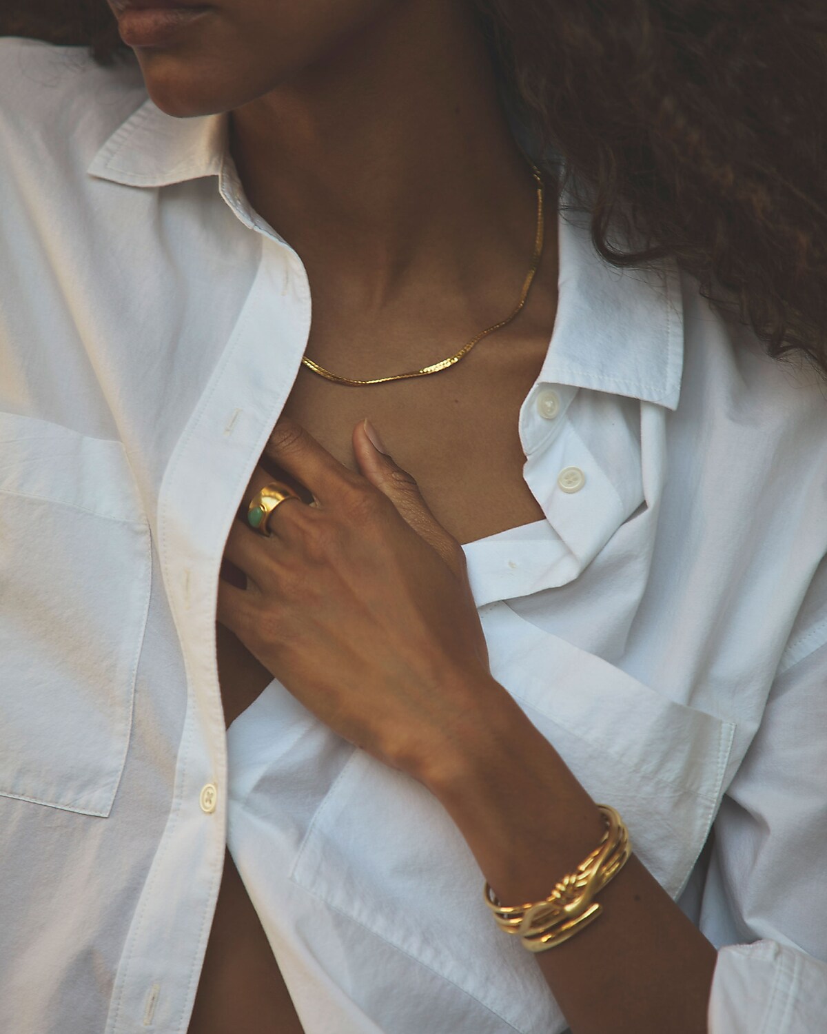 man standing in front of a parachute with classic beige shorts, white top, and a beige shirt