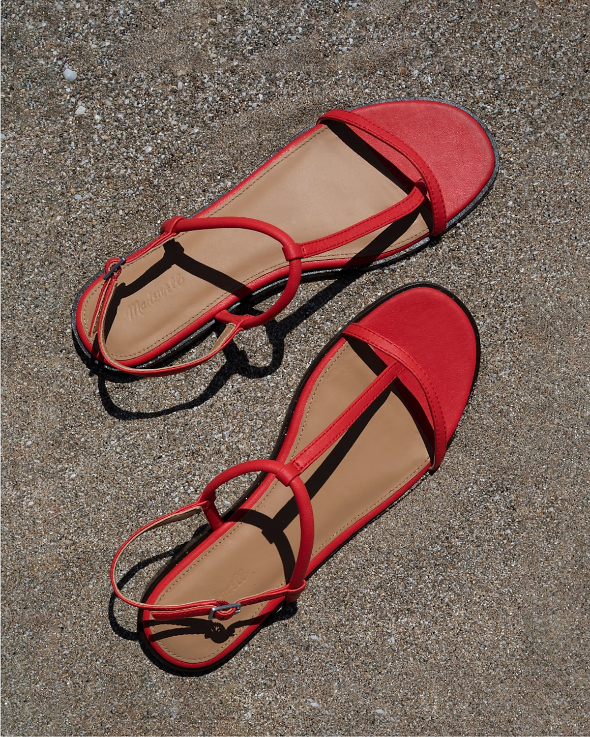 man standing in front of a parachute with classic beige shorts, white top, and a beige shirt