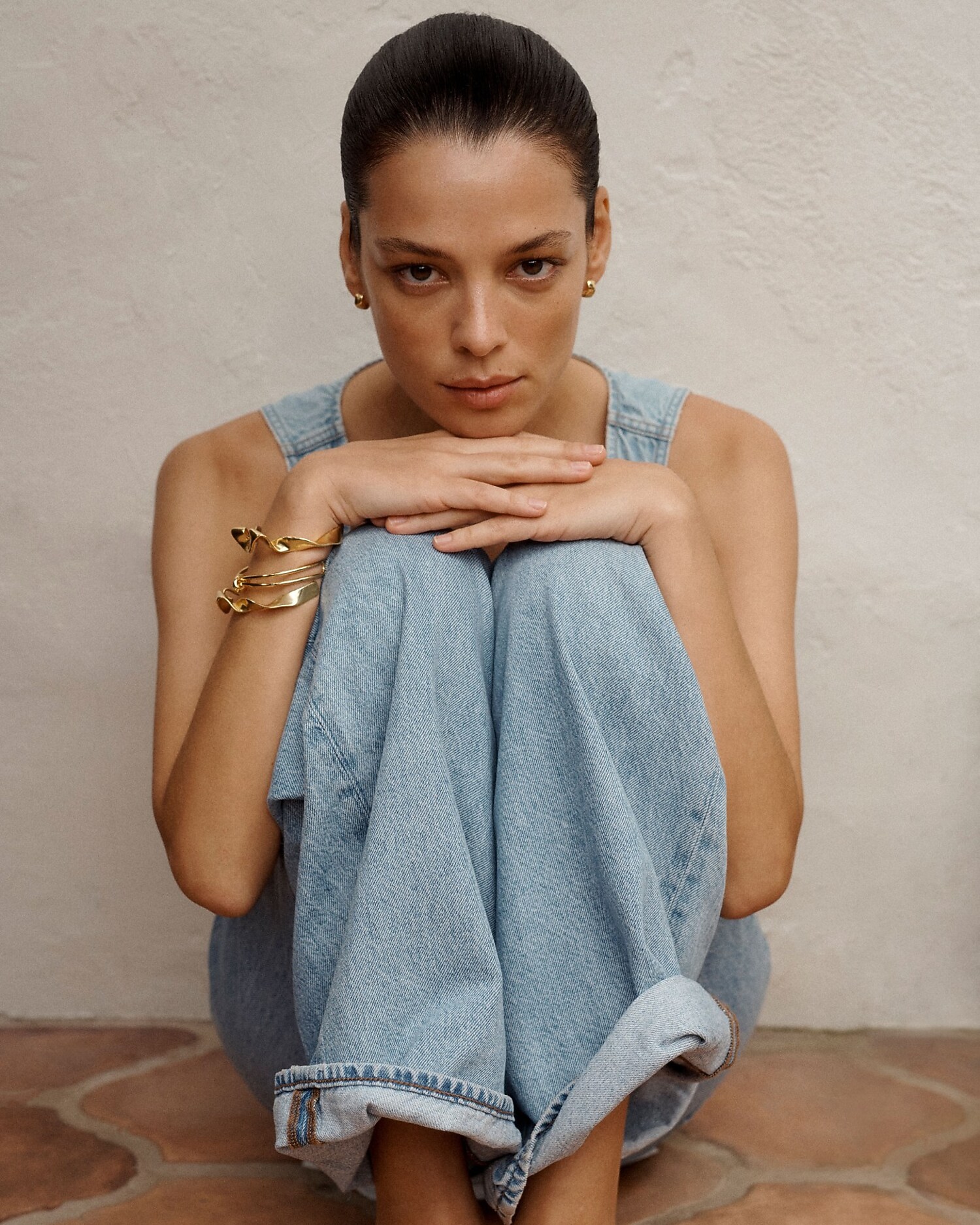 man standing in front of a parachute with classic beige shorts, white top, and a beige shirt