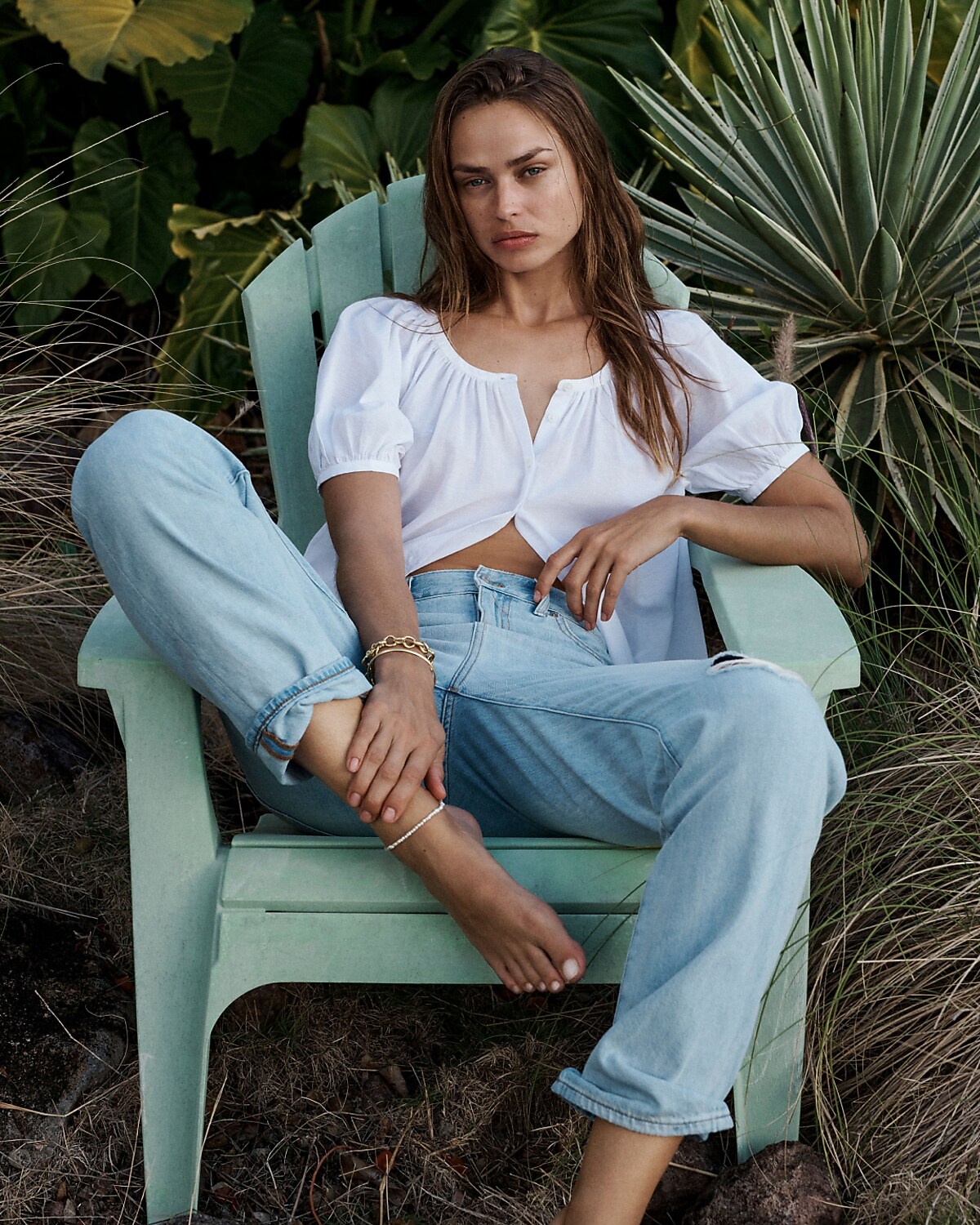 man standing in front of a parachute with classic beige shorts, white top, and a beige shirt