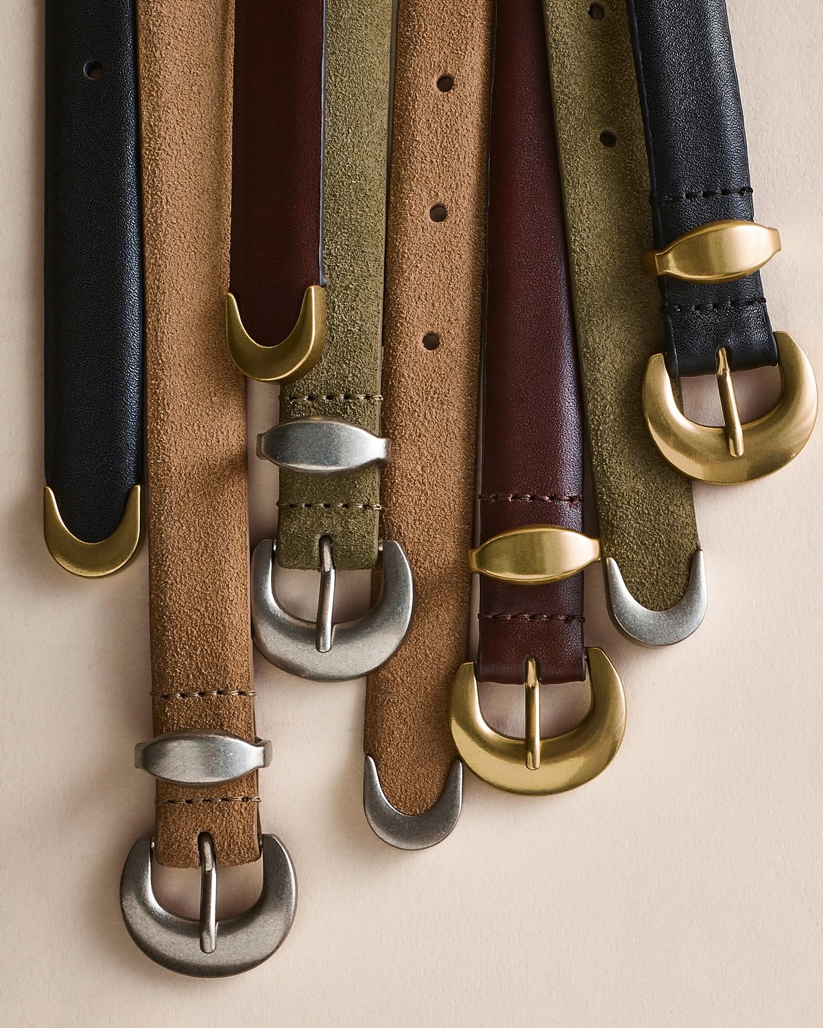 man standing in front of a parachute  with classic beige shorts, white top, and a beige shirt