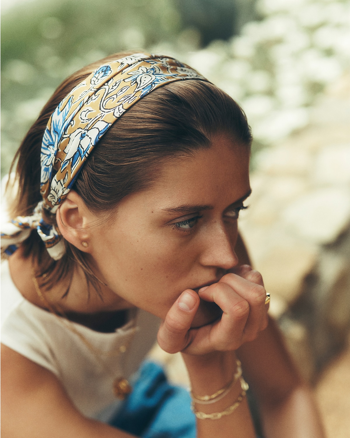 man standing in front of a parachute with classic beige shorts, white top, and a beige shirt