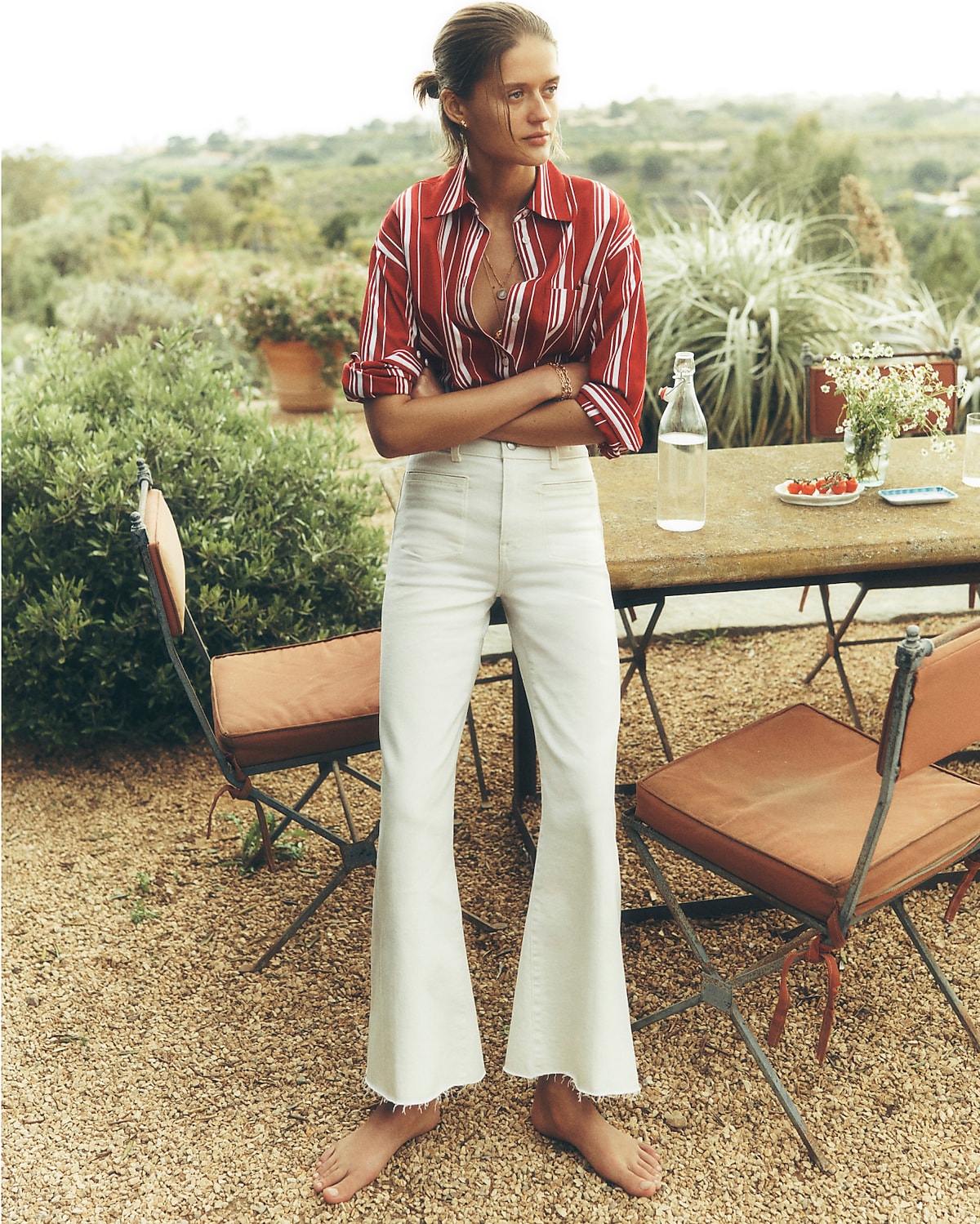 man standing in front of a parachute with classic beige shorts, white top, and a beige shirt