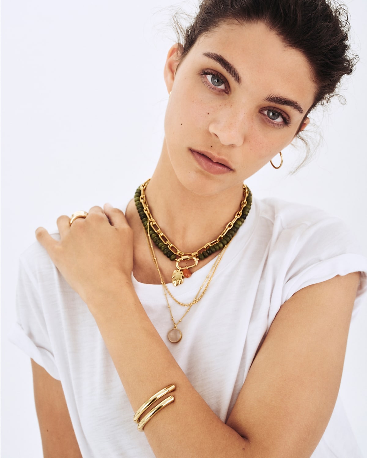 man standing in front of a parachute with classic beige shorts, white top, and a beige shirt