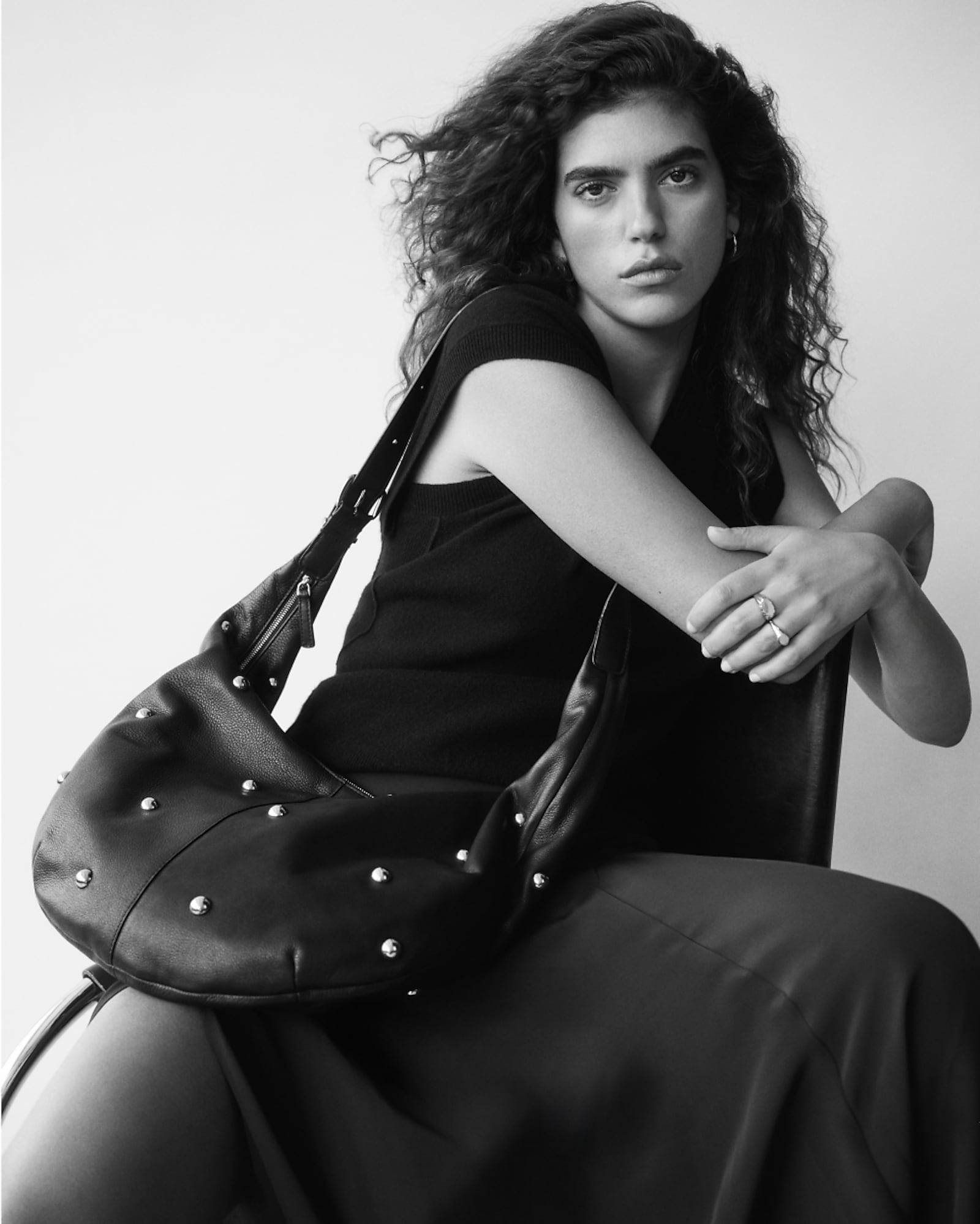 man standing in front of a parachute with classic beige shorts, white top, and a beige shirt