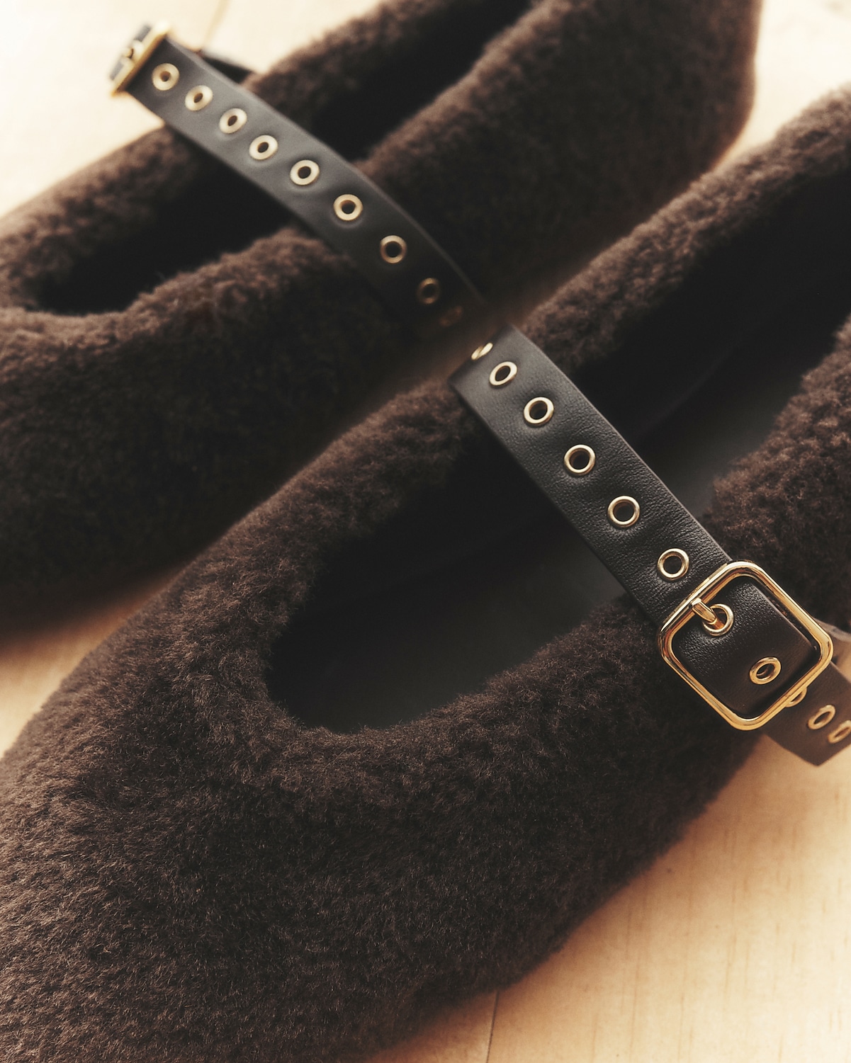 man standing in front of a parachute  with classic beige shorts, white top, and a beige shirt