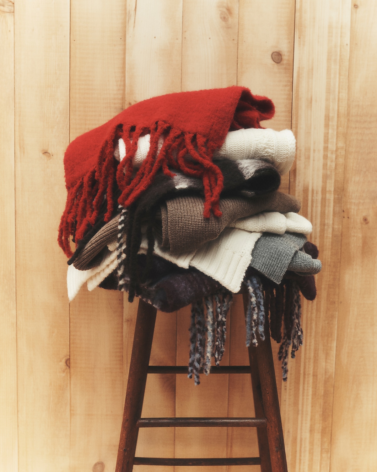 man standing in front of a parachute with classic beige shorts, white top, and a beige shirt