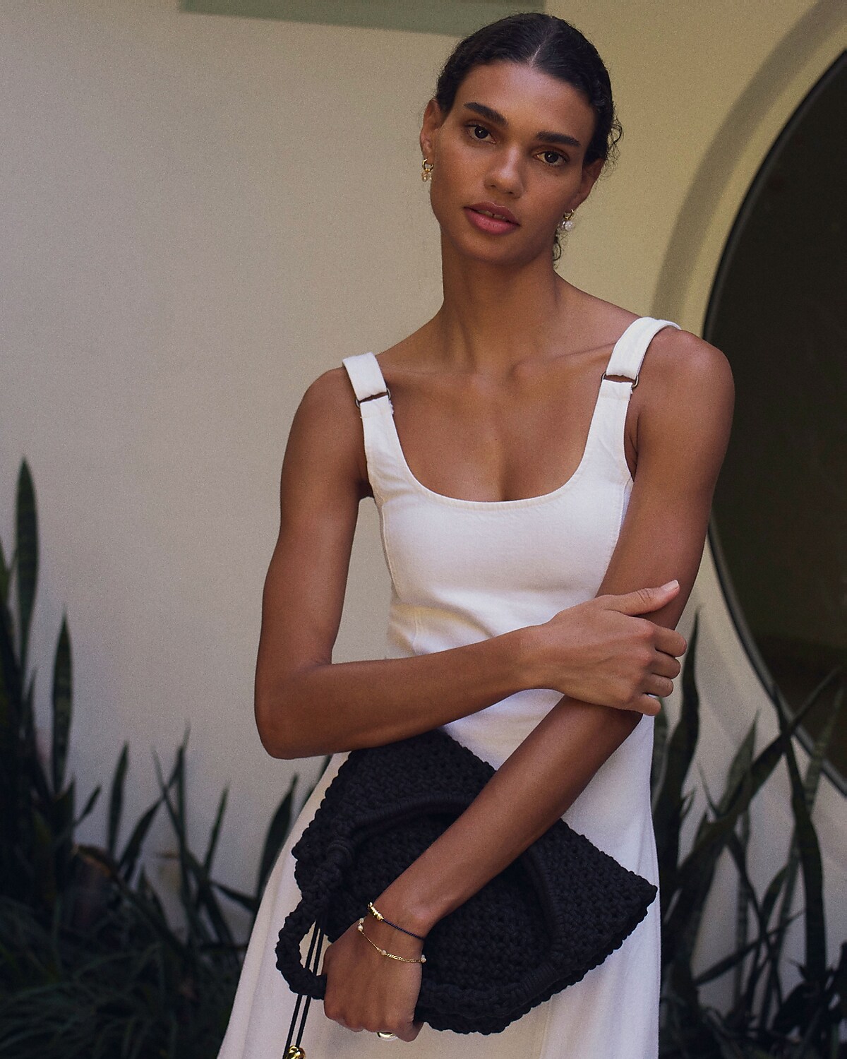 man standing in front of a parachute with classic beige shorts, white top, and a beige shirt
