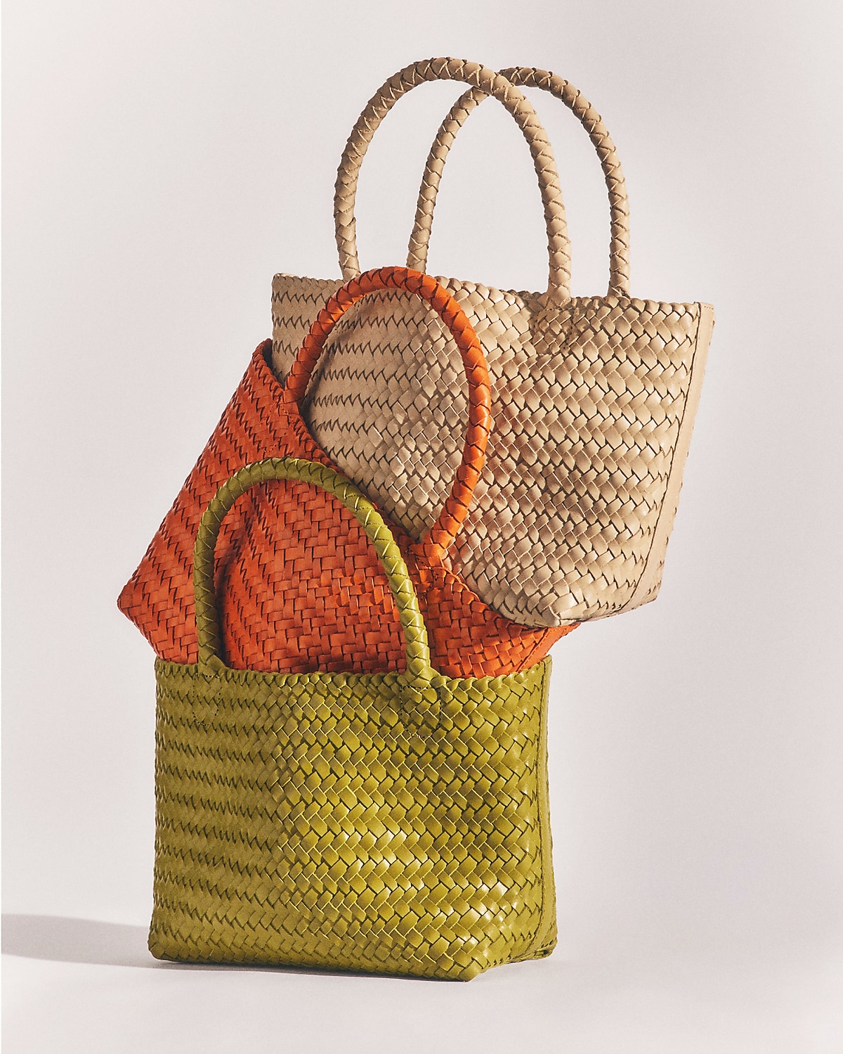 man standing in front of a parachute with classic beige shorts, white top, and a beige shirt