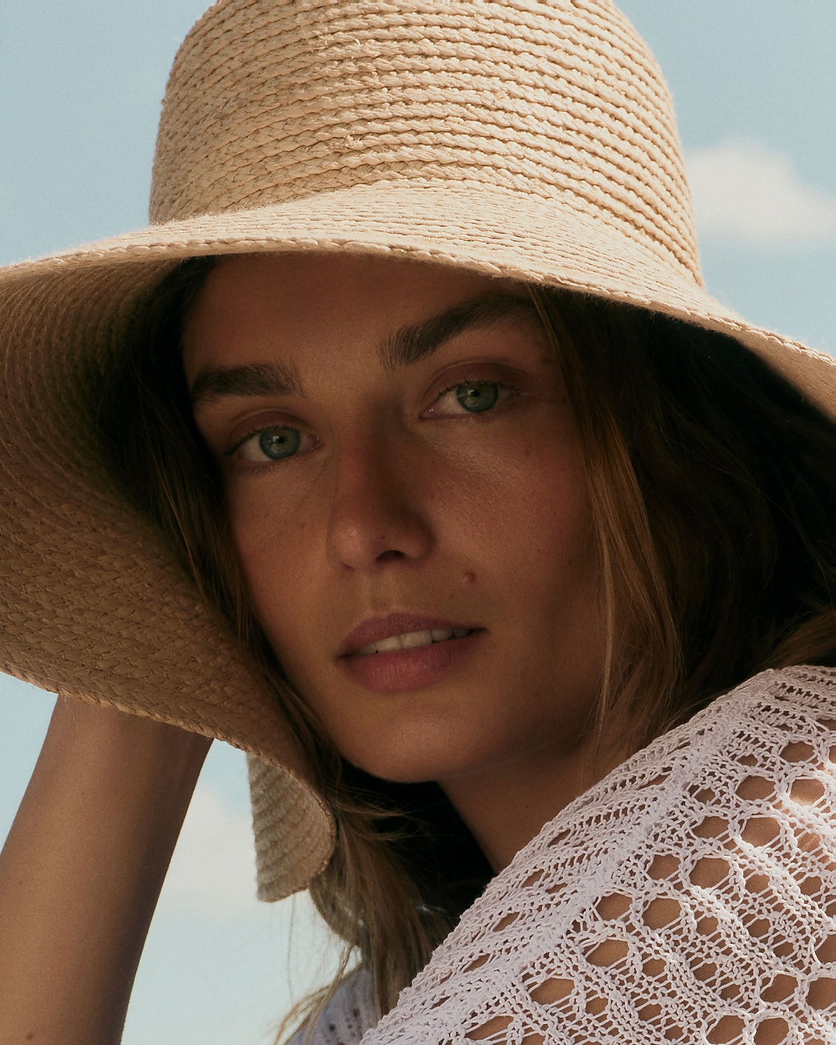 man standing in front of a parachute with classic beige shorts, white top, and a beige shirt