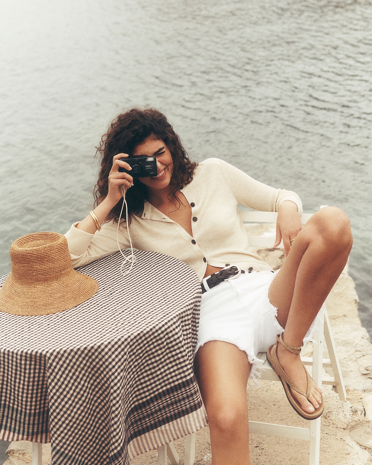 man standing in front of a parachute with classic beige shorts, white top, and a beige shirt
