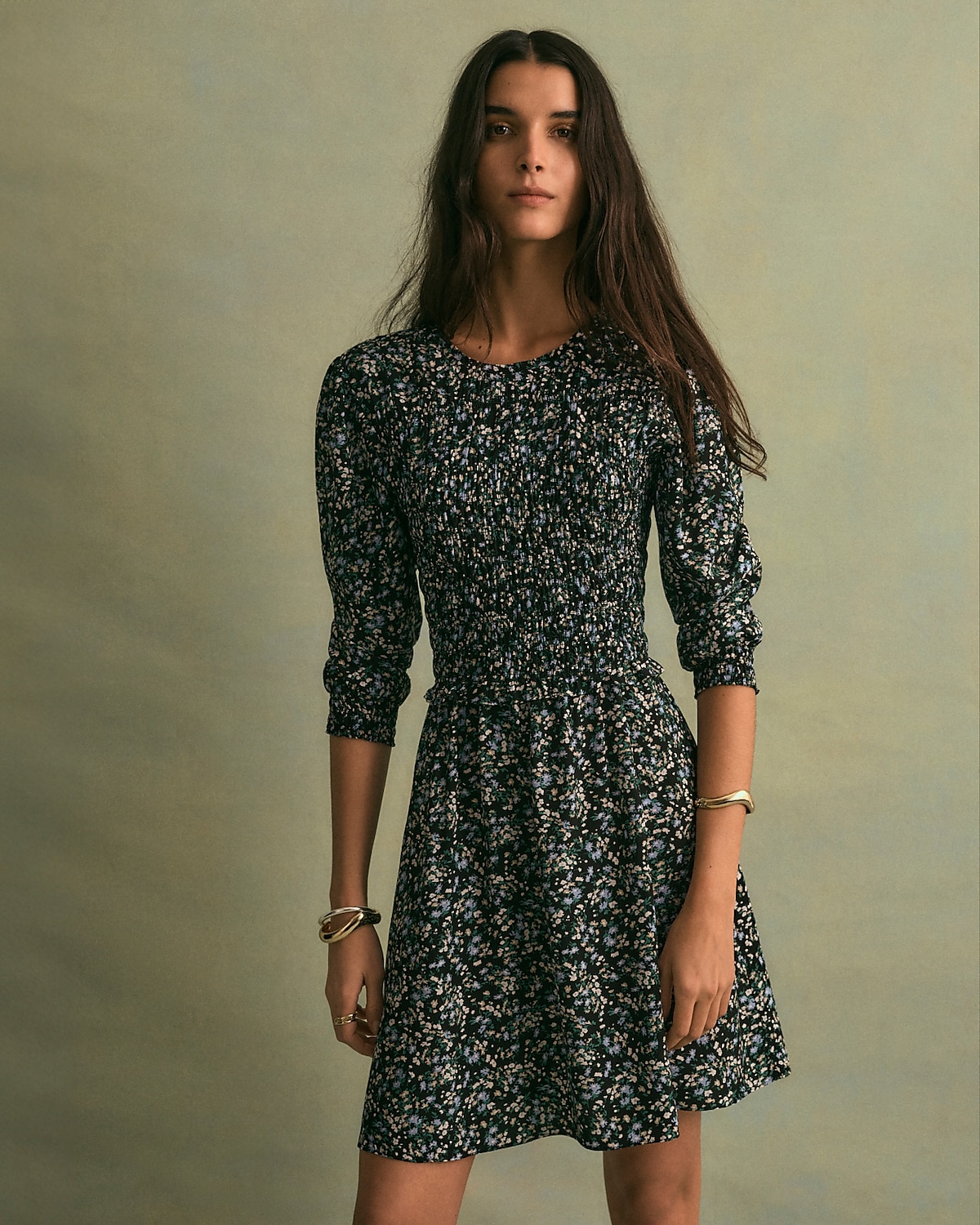 man standing in front of a parachute with classic beige shorts, white top, and a beige shirt