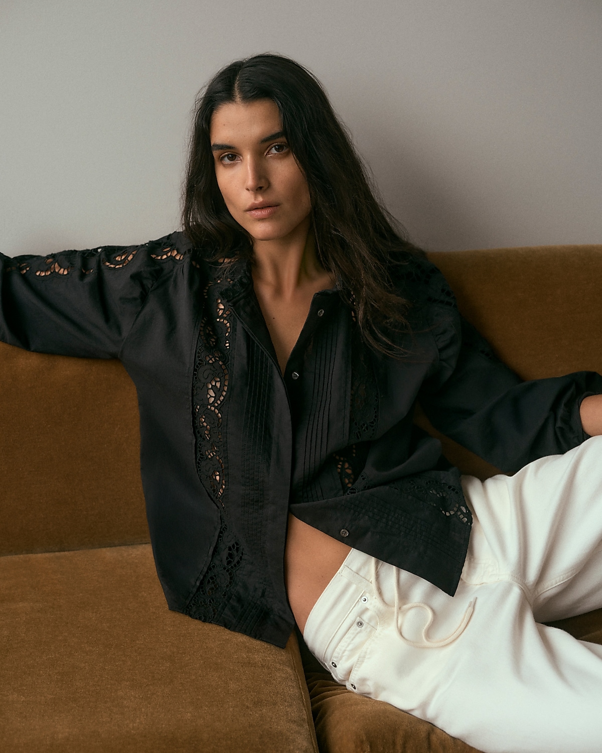 man standing in front of a parachute with classic beige shorts, white top, and a beige shirt