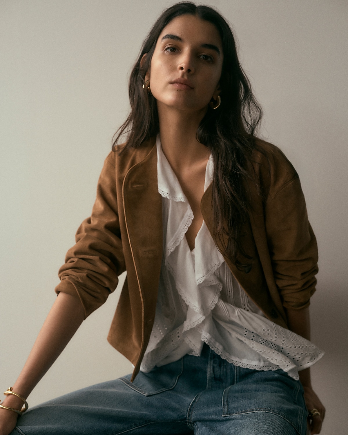 man standing in front of a parachute with classic beige shorts, white top, and a beige shirt
