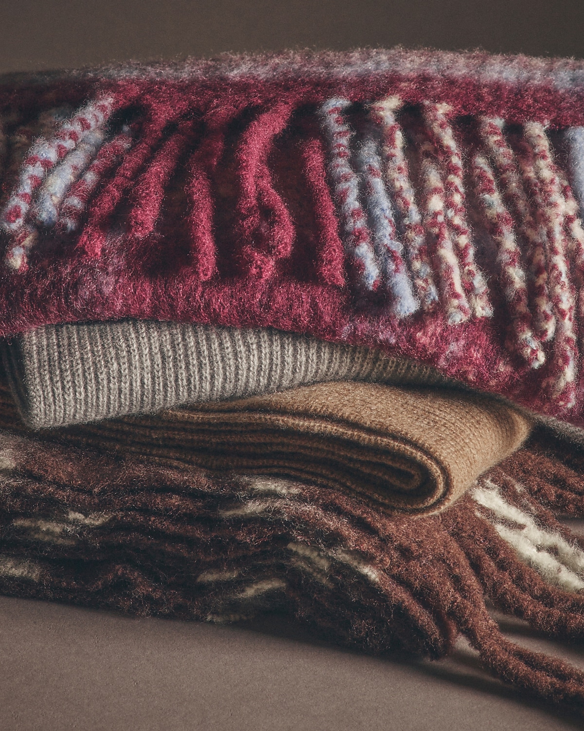 man standing in front of a parachute  with classic beige shorts, white top, and a beige shirt