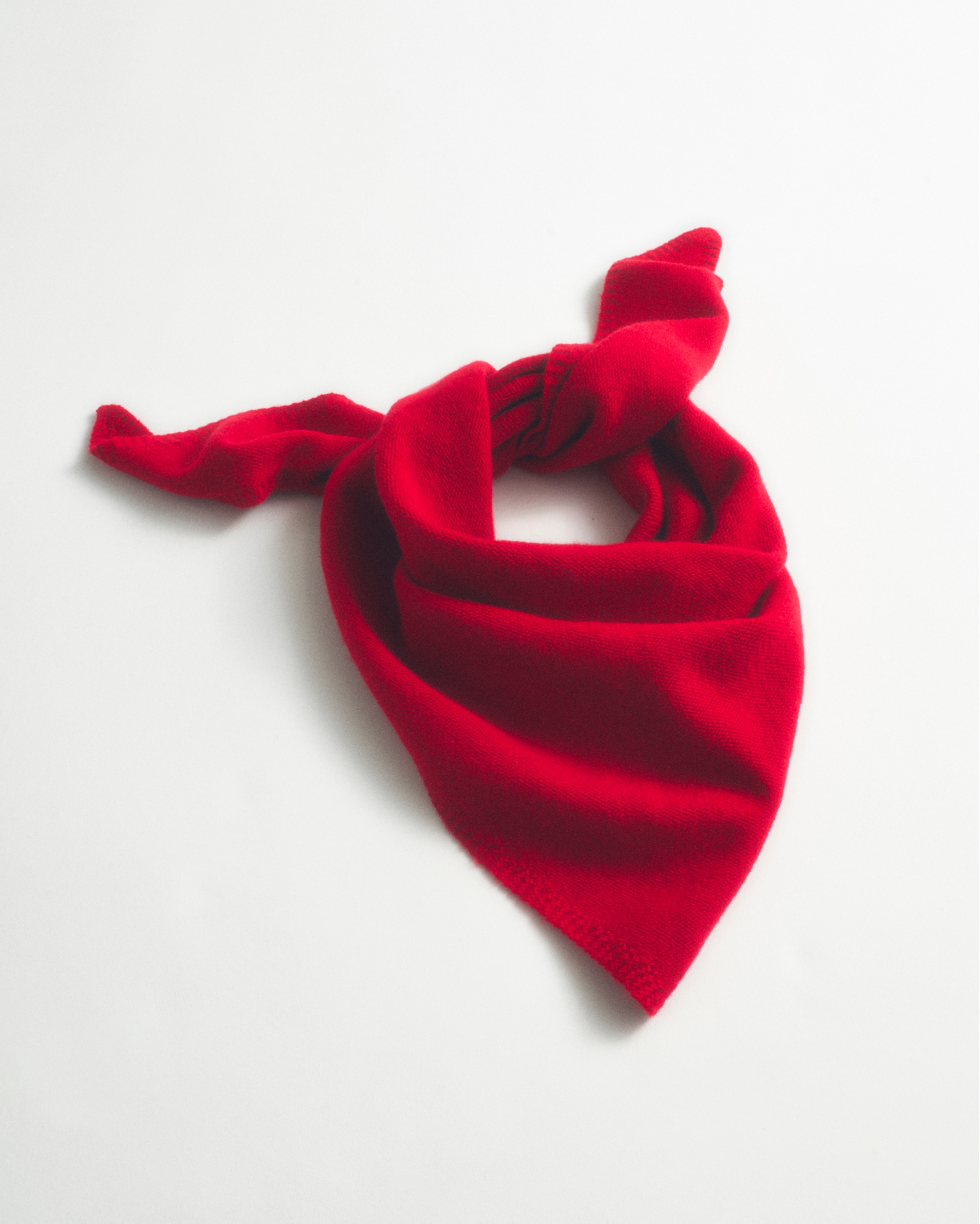 man standing in front of a parachute  with classic beige shorts, white top, and a beige shirt