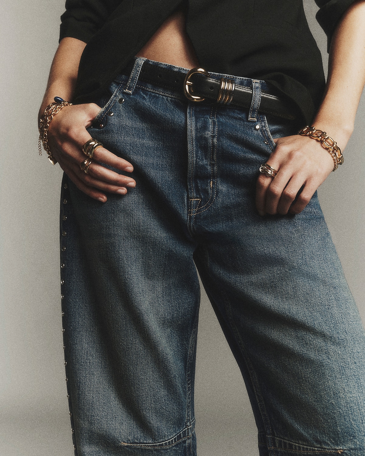 man standing in front of a parachute  with classic beige shorts, white top, and a beige shirt