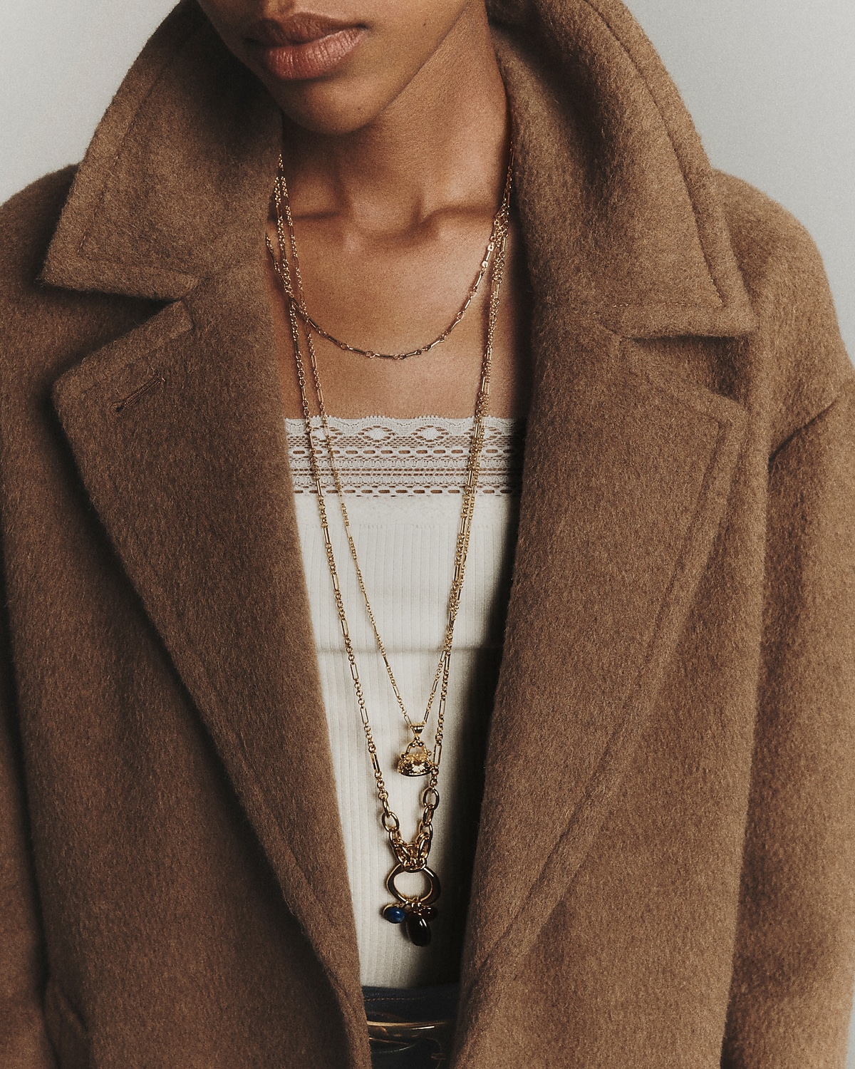 man standing in front of a parachute  with classic beige shorts, white top, and a beige shirt