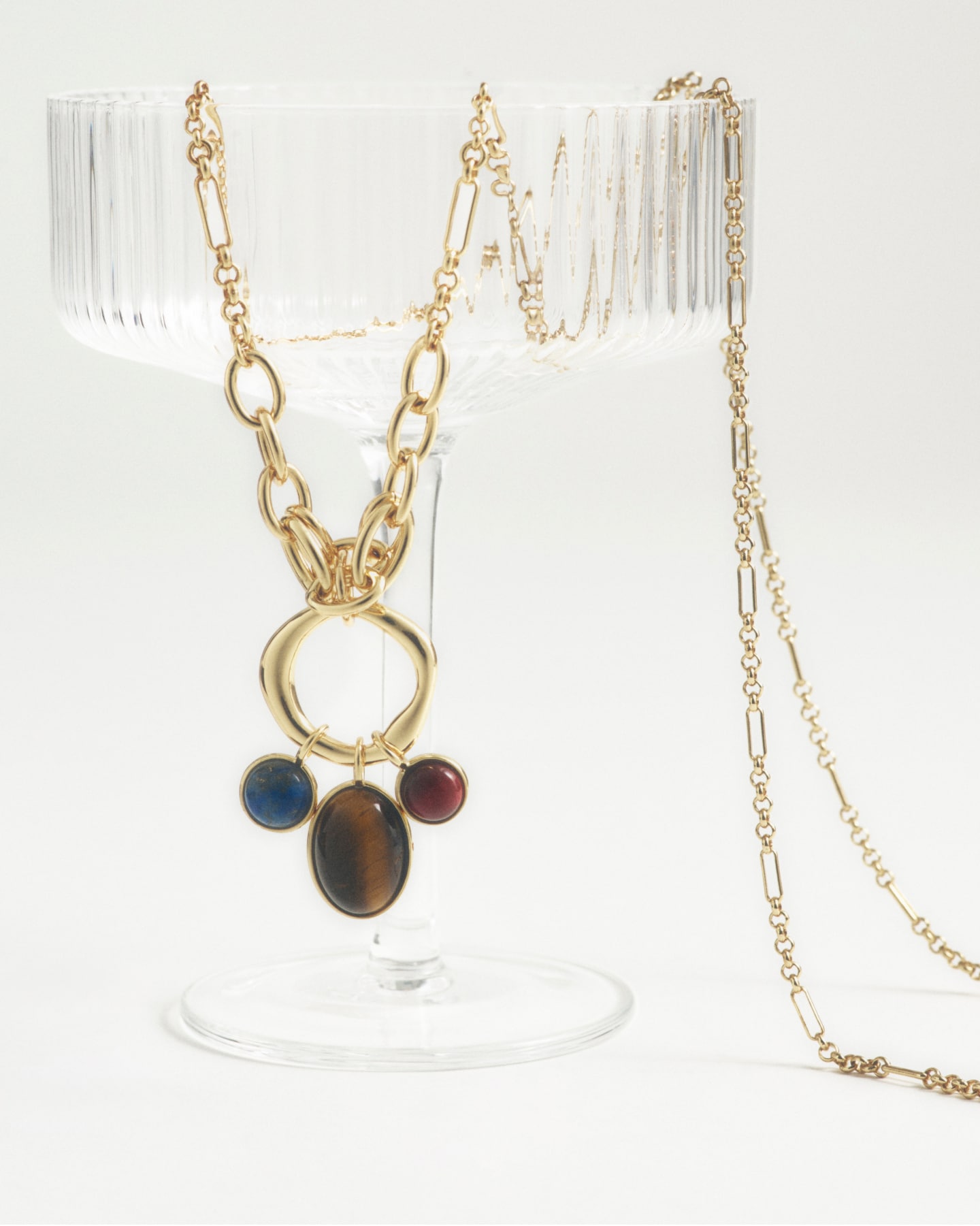 man standing in front of a parachute  with classic beige shorts, white top, and a beige shirt