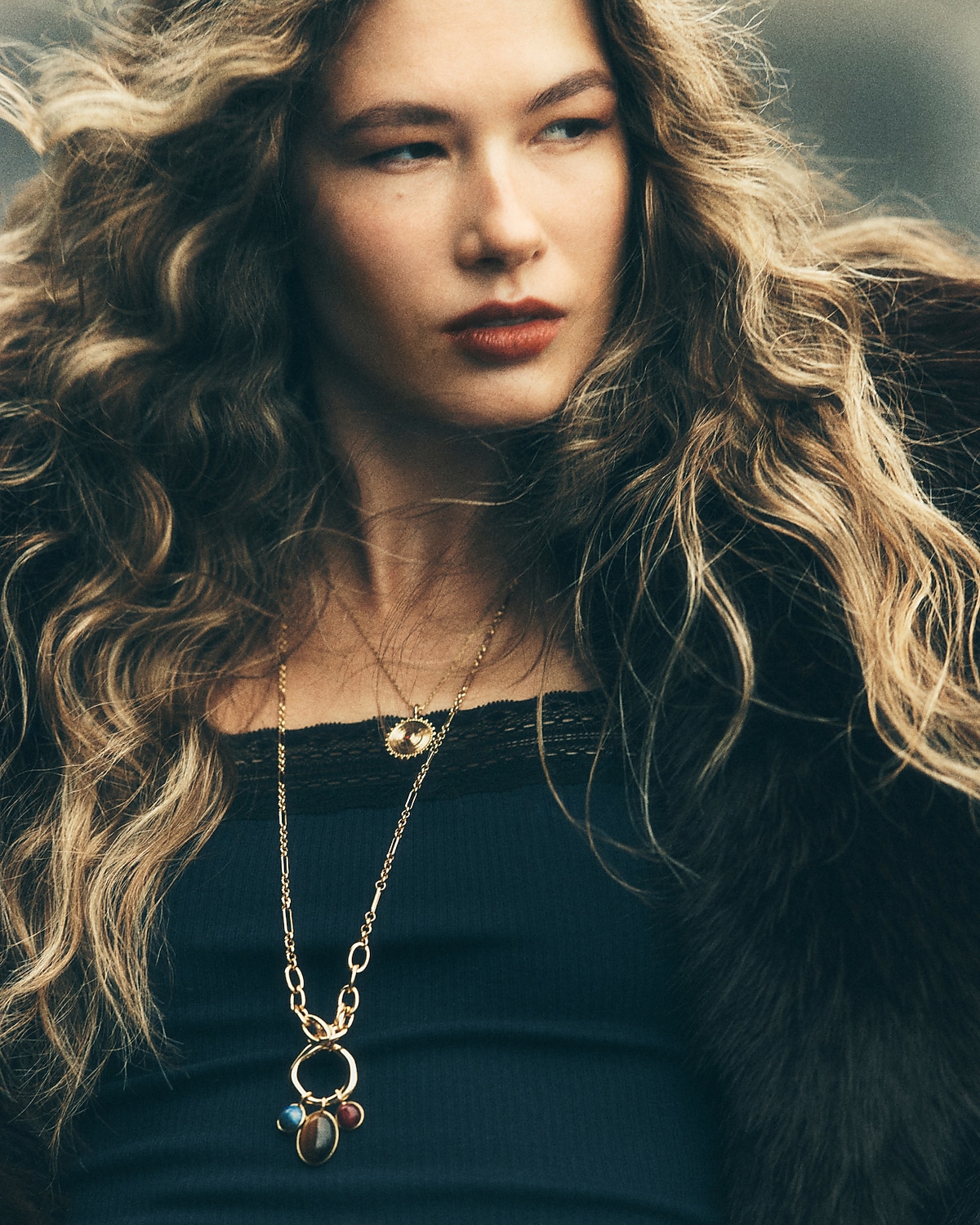 man standing in front of a parachute  with classic beige shorts, white top, and a beige shirt