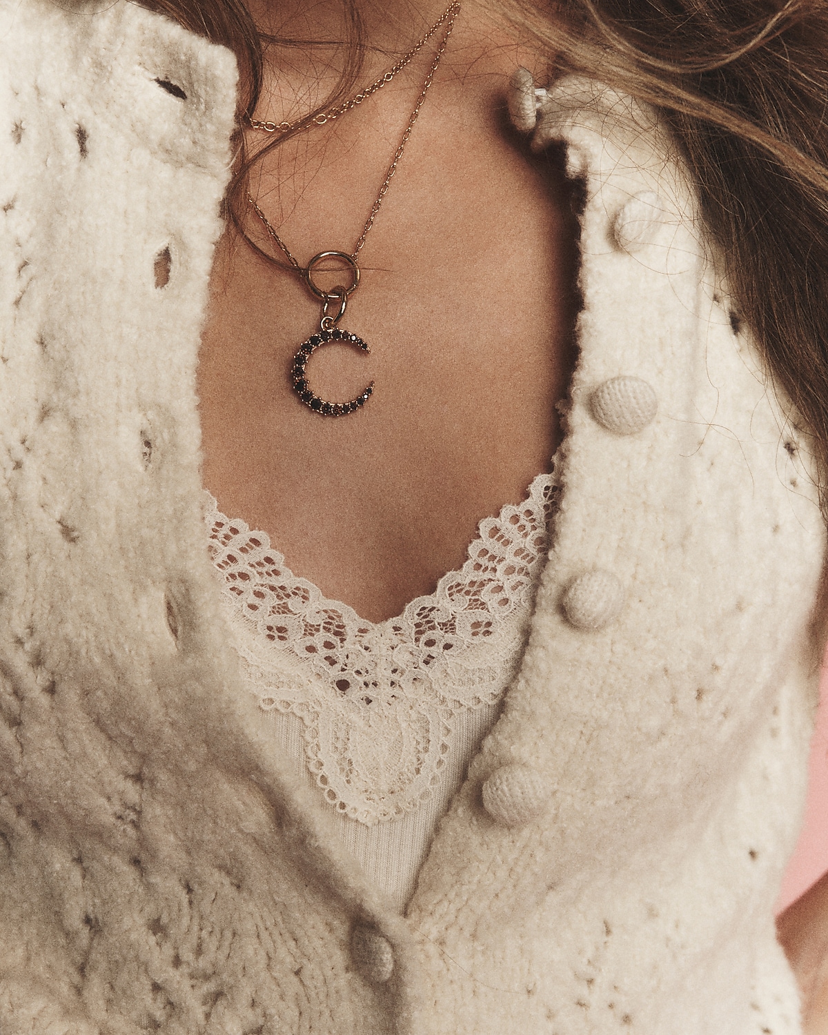 man standing in front of a parachute  with classic beige shorts, white top, and a beige shirt