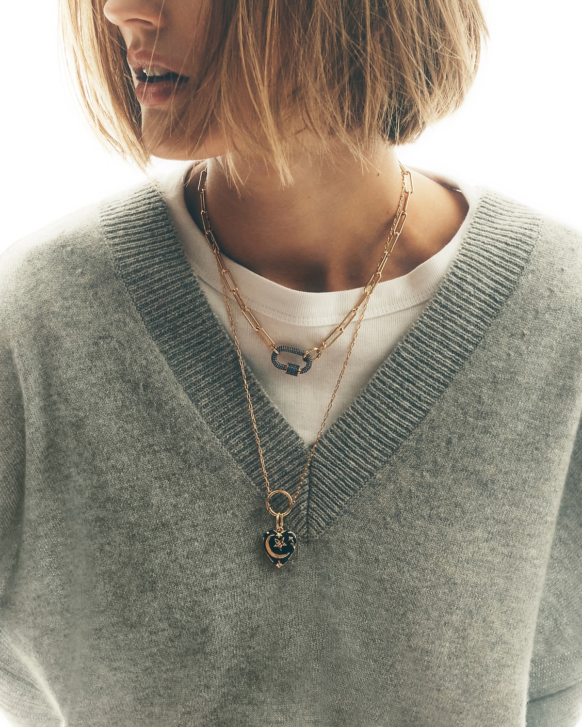 man standing in front of a parachute  with classic beige shorts, white top, and a beige shirt