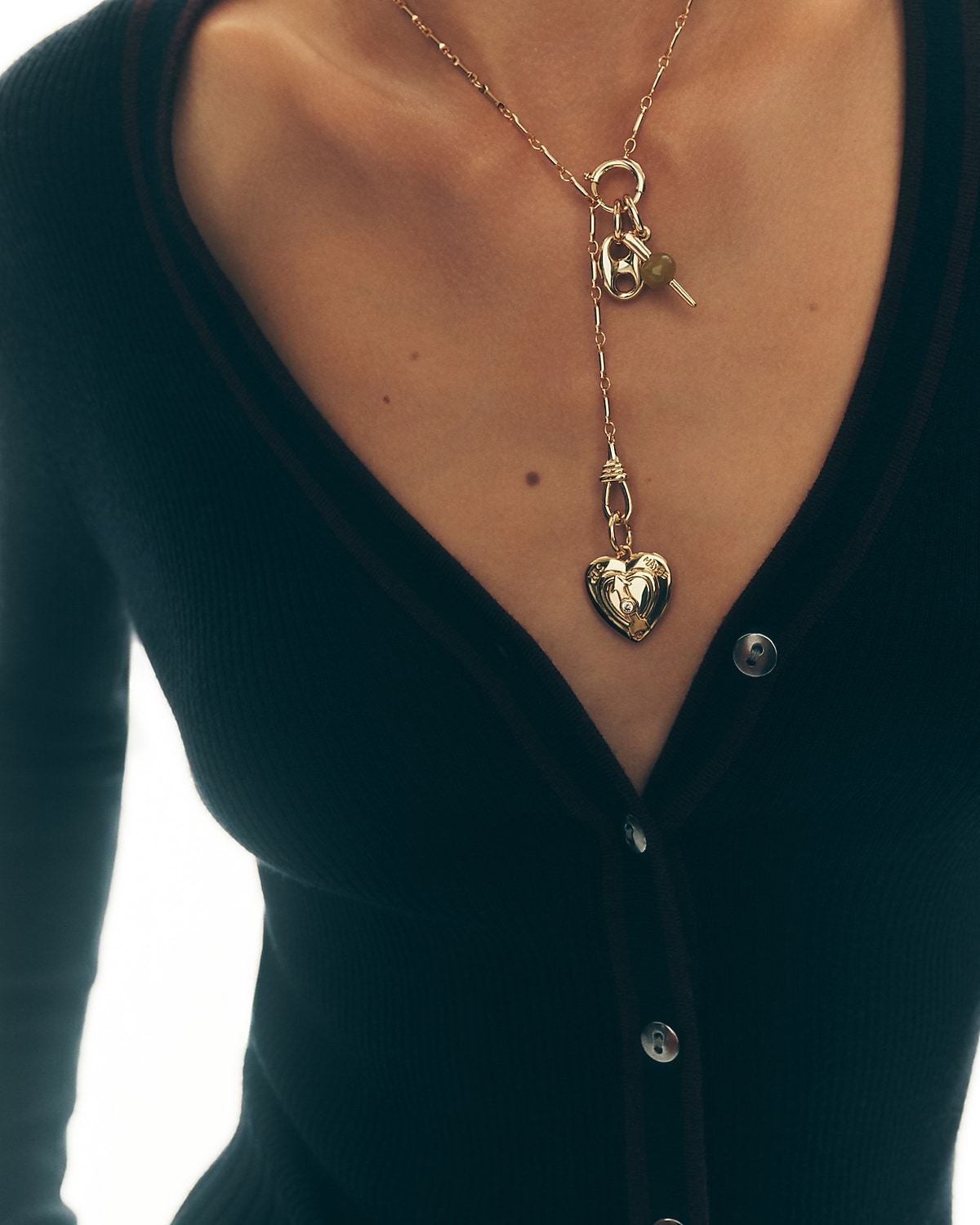 man standing in front of a parachute  with classic beige shorts, white top, and a beige shirt