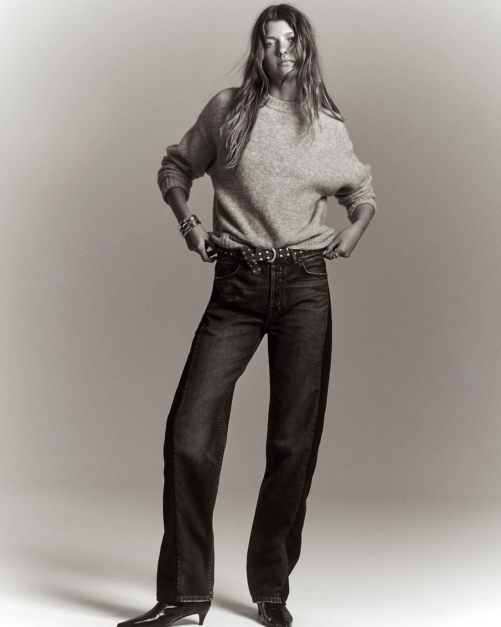 man standing in front of a parachute with classic beige shorts, white top, and a beige shirt