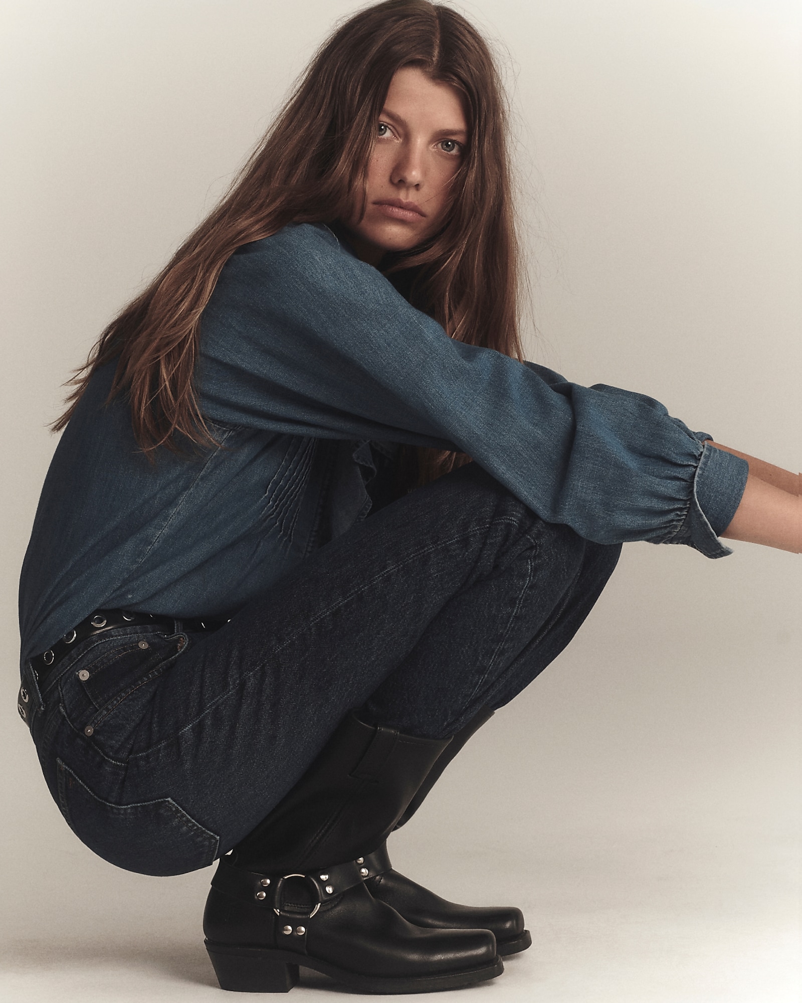man standing in front of a parachute with classic beige shorts, white top, and a beige shirt