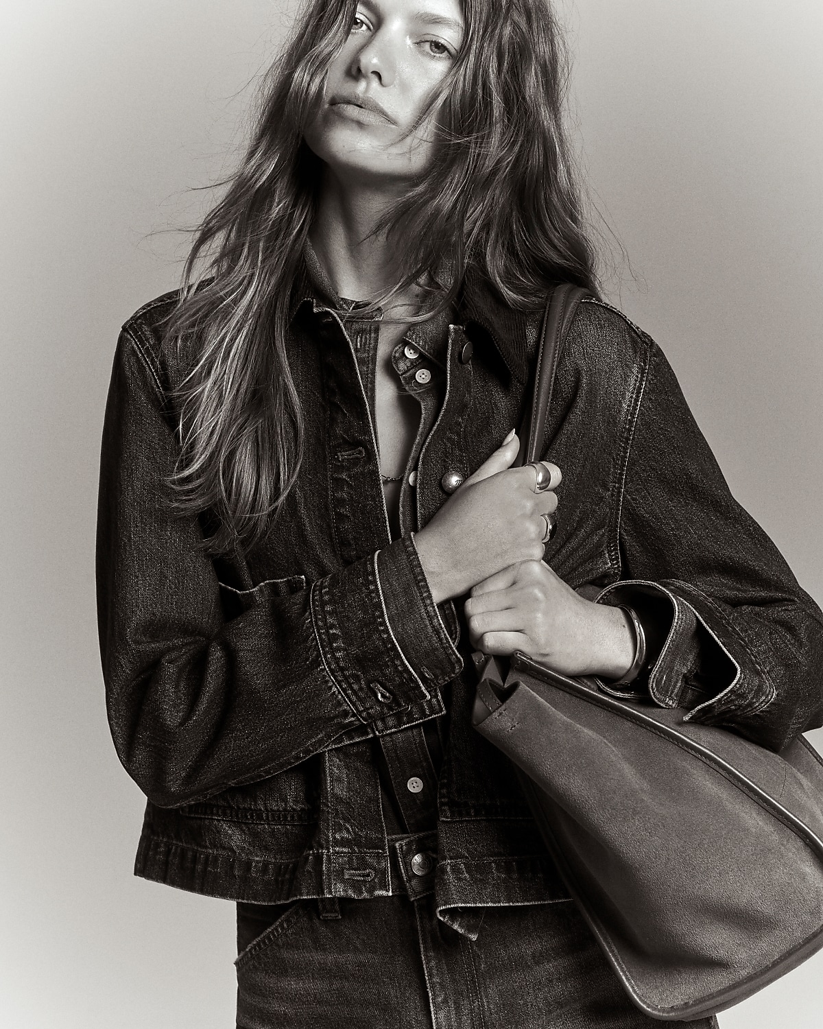 man standing in front of a parachute with classic beige shorts, white top, and a beige shirt