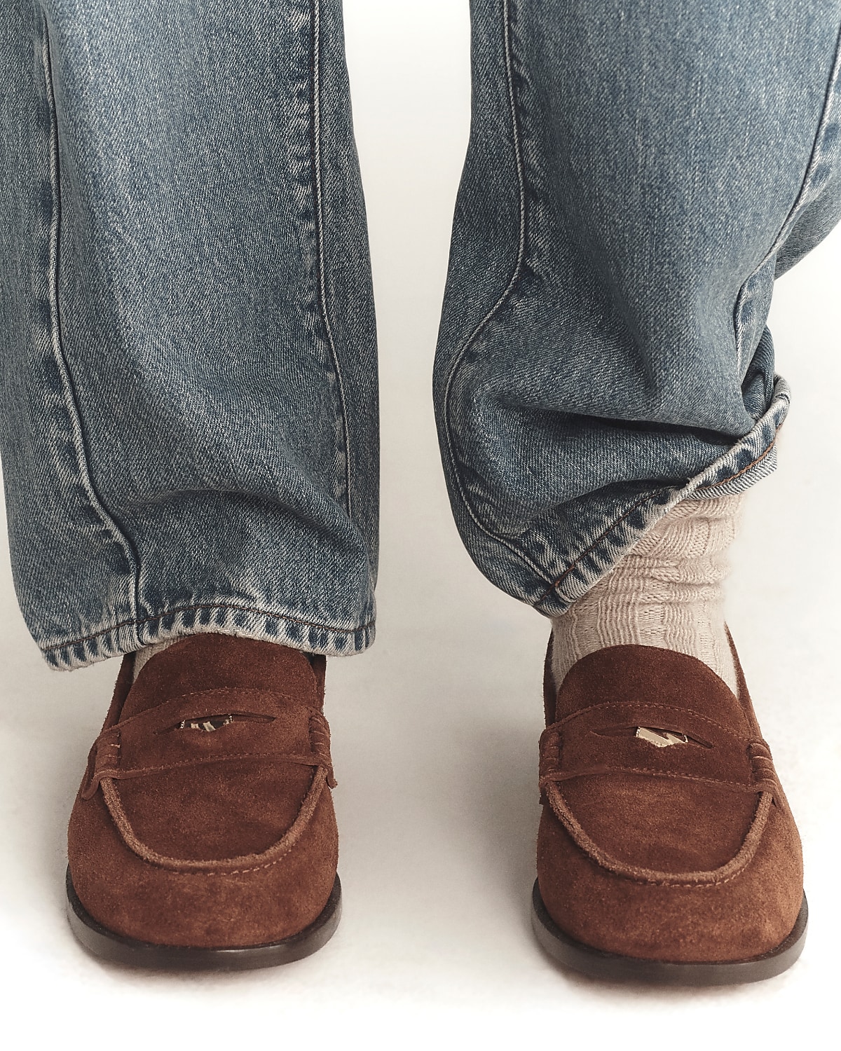 man standing in front of a parachute with classic beige shorts, white top, and a beige shirt