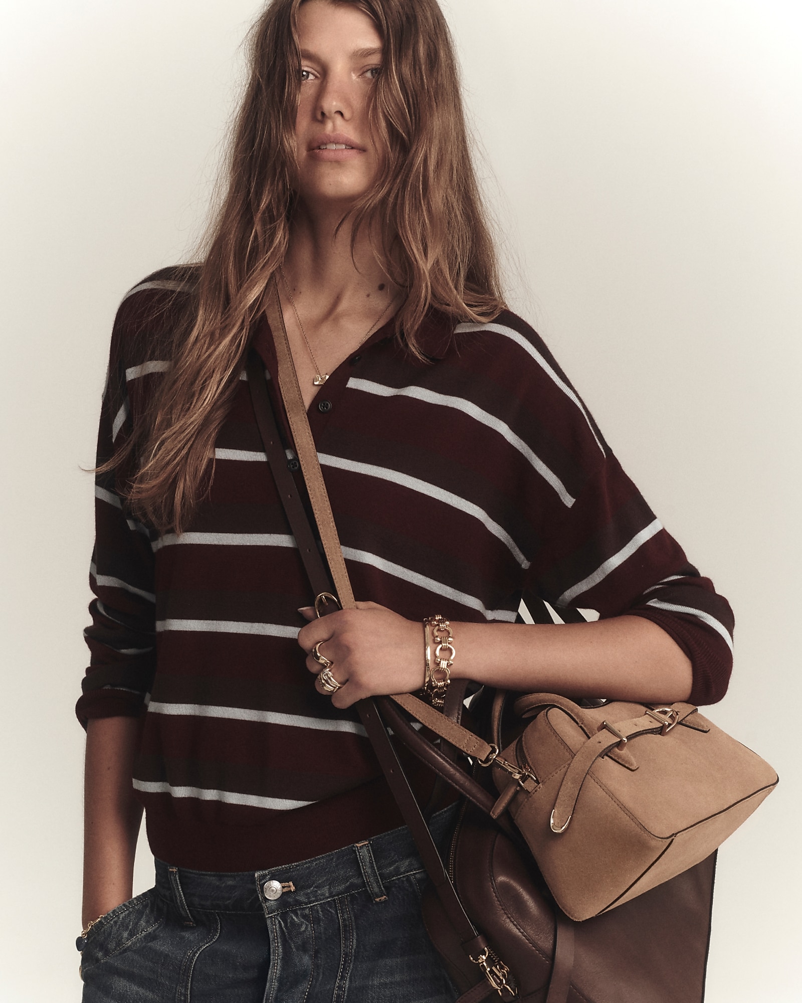 man standing in front of a parachute with classic beige shorts, white top, and a beige shirt