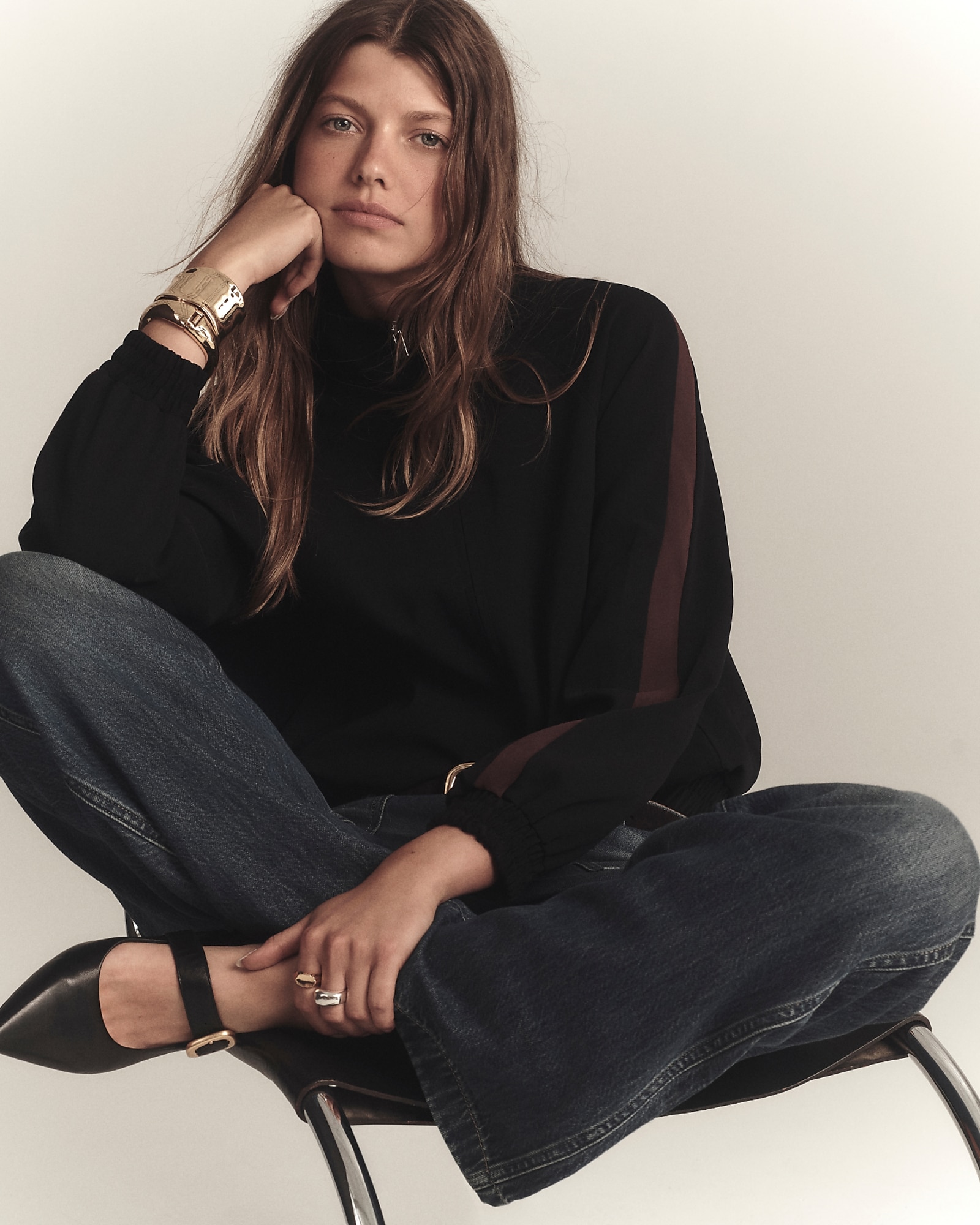 man standing in front of a parachute with classic beige shorts, white top, and a beige shirt