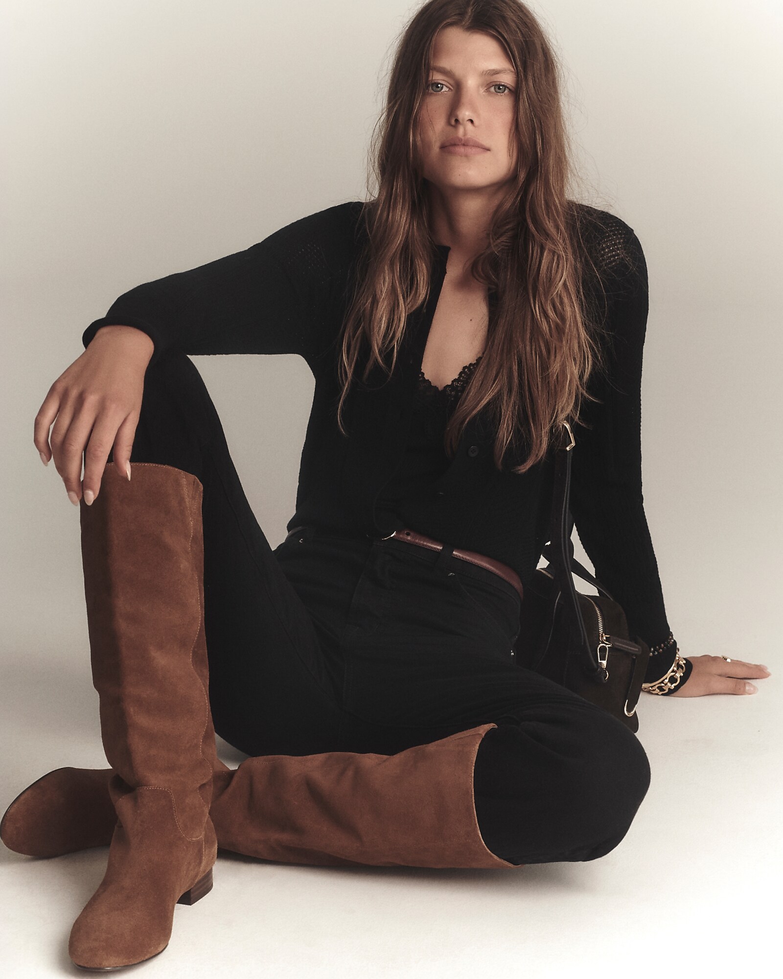 man standing in front of a parachute with classic beige shorts, white top, and a beige shirt