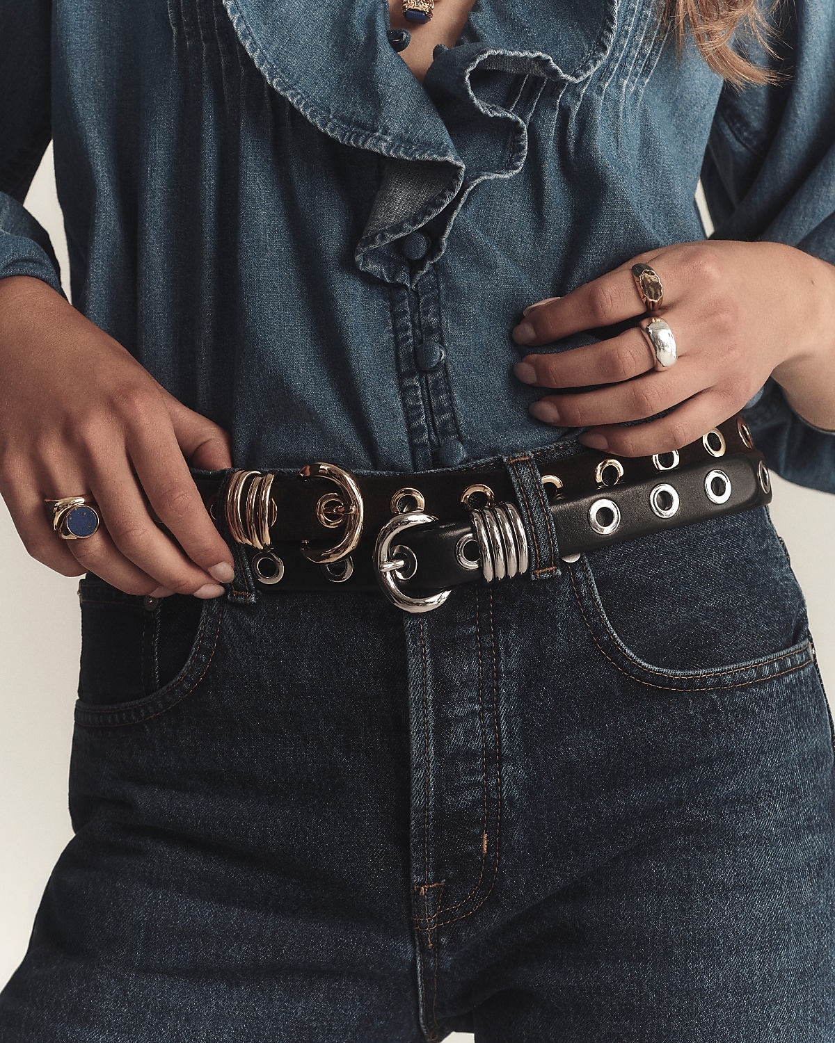 man standing in front of a parachute with classic beige shorts, white top, and a beige shirt